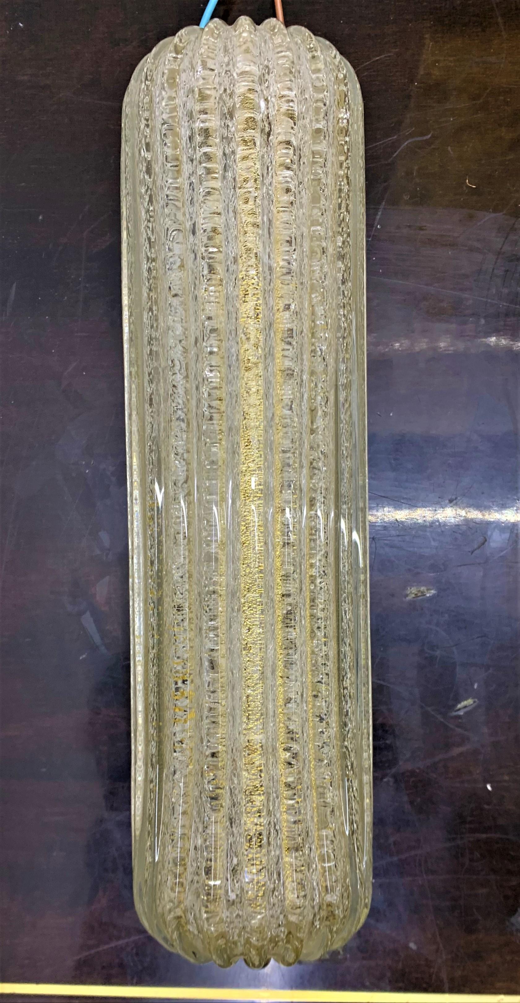 Pair of Mid-Century Modern wall lights or sconces manufactured in brass, iron and clear Murano glass with gold inclusions by Barovier & Toso in Murano Italy, circa 1960
Both still retaining original paper labels.
They're both the same size. Due to