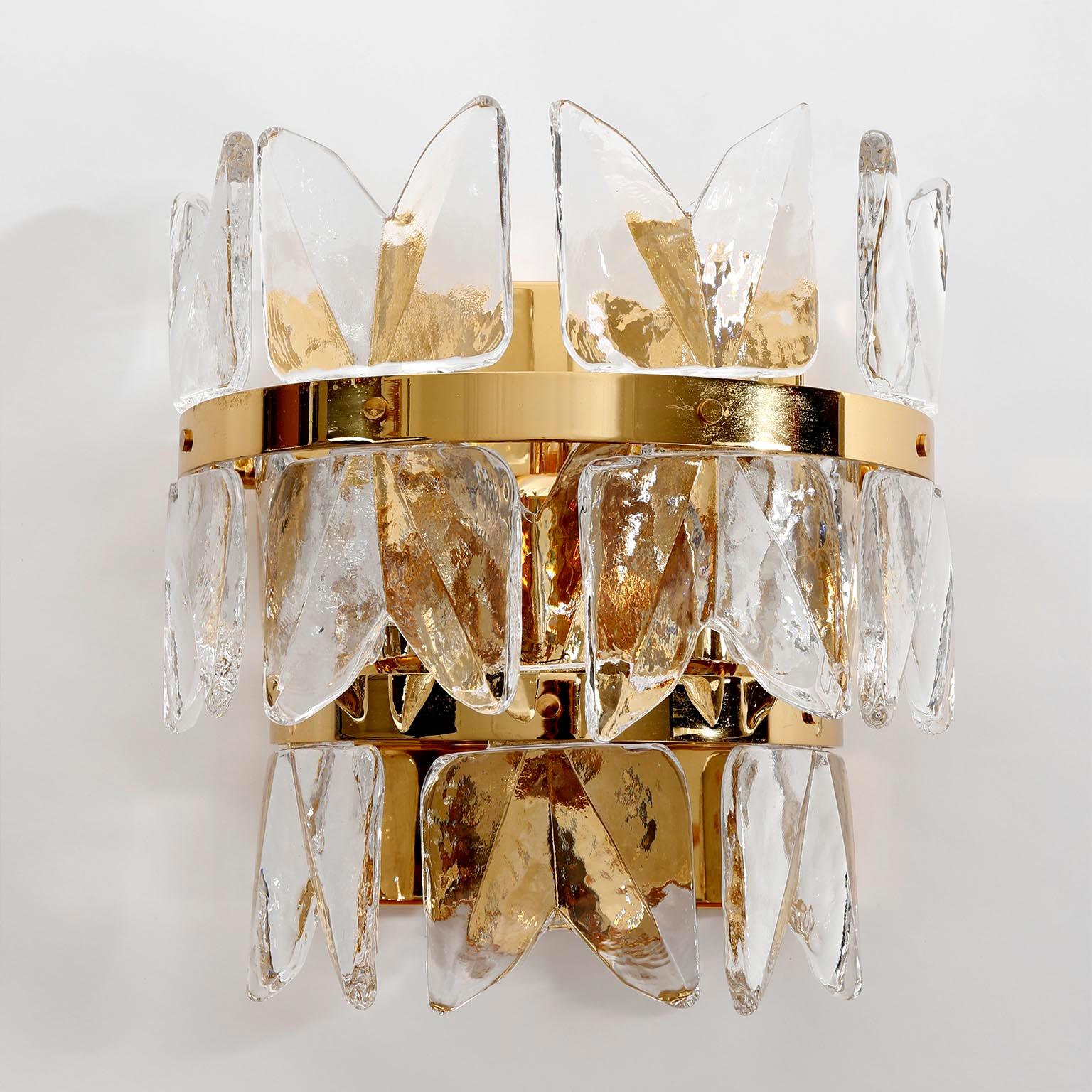 A pair of very exclusive Hollywood regency ice glass wall lamps model 'Corina' by J.T. Kalmar, Vienna, Austria, manufactured in midcentury, circa 1970 (late 1960s or early 1970s).
High quality items which are made of a 24-carat gilded polished brass