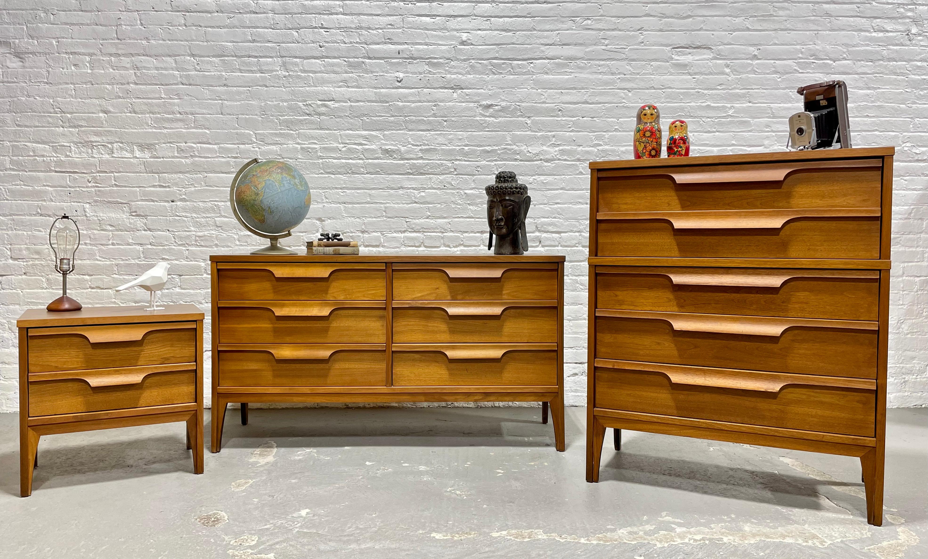 Mid Century Modern Sculpted Bedroom Set by Johnson Carper., c. 1960's, consisting of Long Dresser, High Dresser and Nightstand.  Each piece features beautiful architectural detailing with sculpted drawers with plenty of drawer space. Laminated