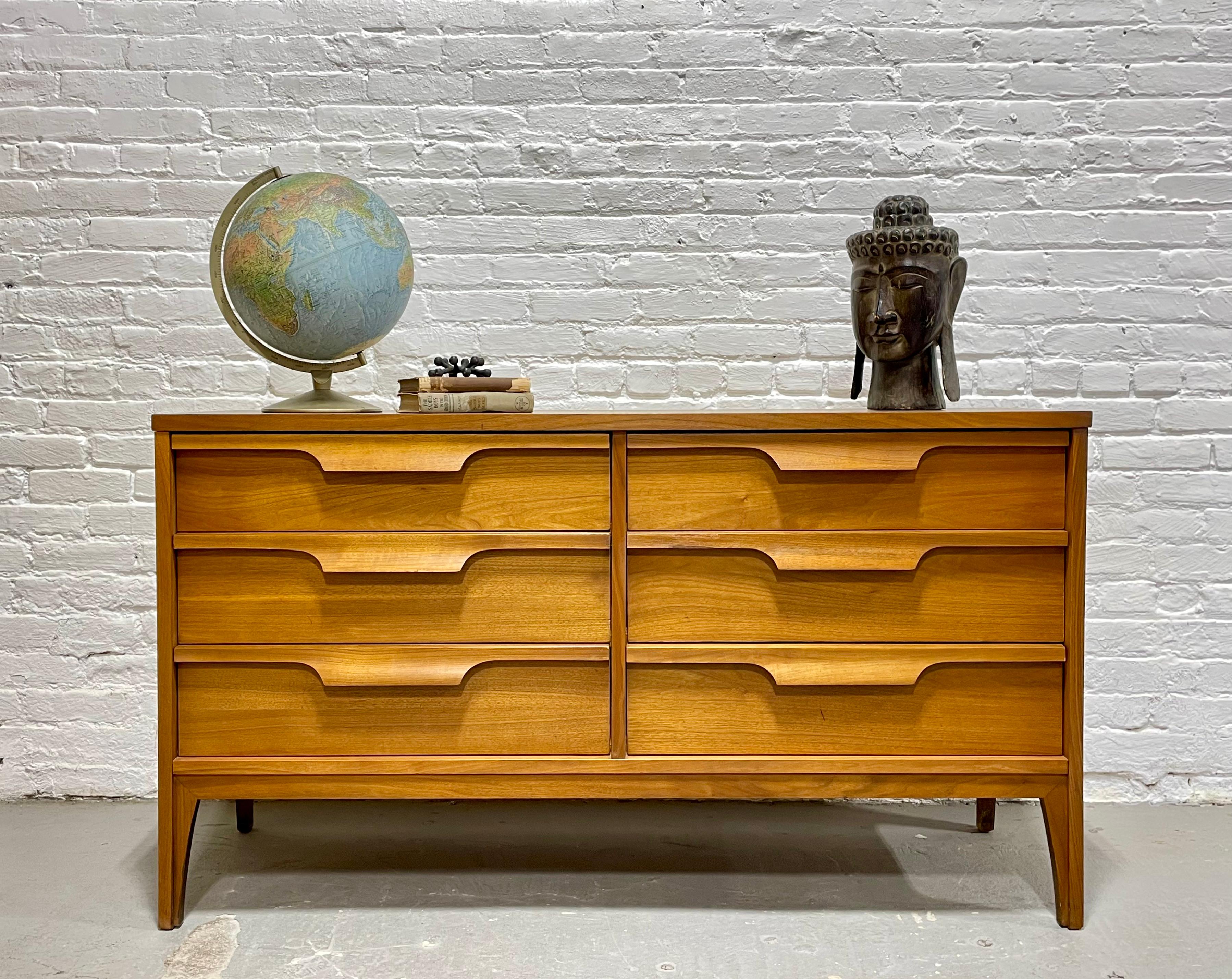 Mid Century Modern Sculpted Long Dresser / Credenza by Johnson Carper., c. 1960's.  Beautiful architectural detailing with sculpted drawers. Six spacious dovetailed drawers offer plenty of storage space. Laminated scratch-resistant woodgrain