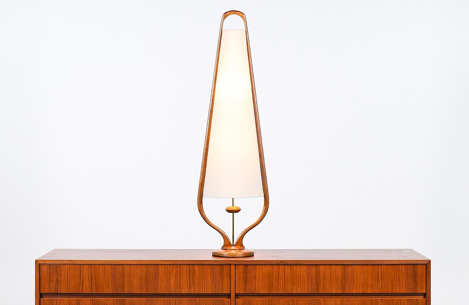 Mid-Century Modern sculpted walnut arc and brass table lamp by Modeline.