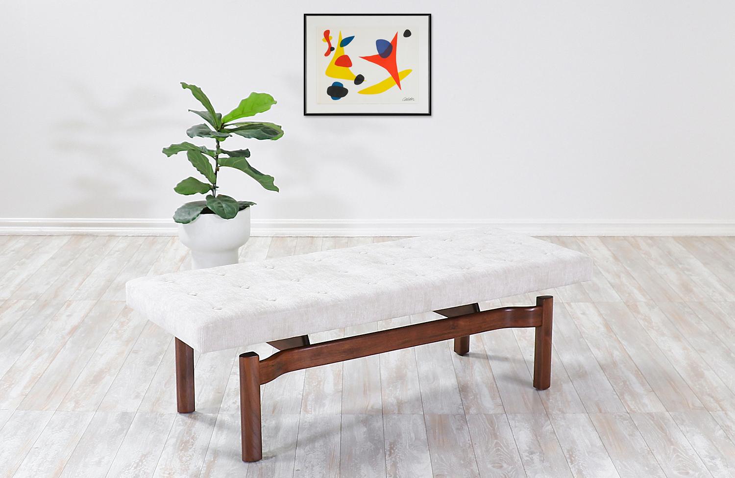 Mid-Century Modern sculpted walnut floating tufted bench.