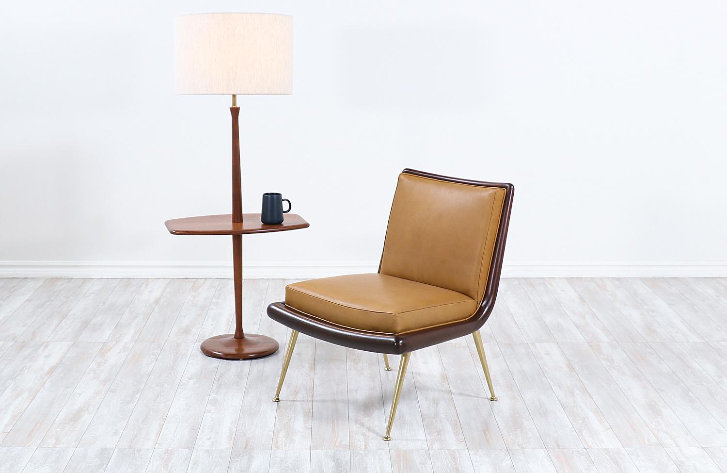 Mid-Century Modern sculpted walnut floor lamp with side table by Laurel.

Dimensions:
53in H x 22in W x 14.5in D
Lamp shade: 12in H x 18in W
Side table height 21in.