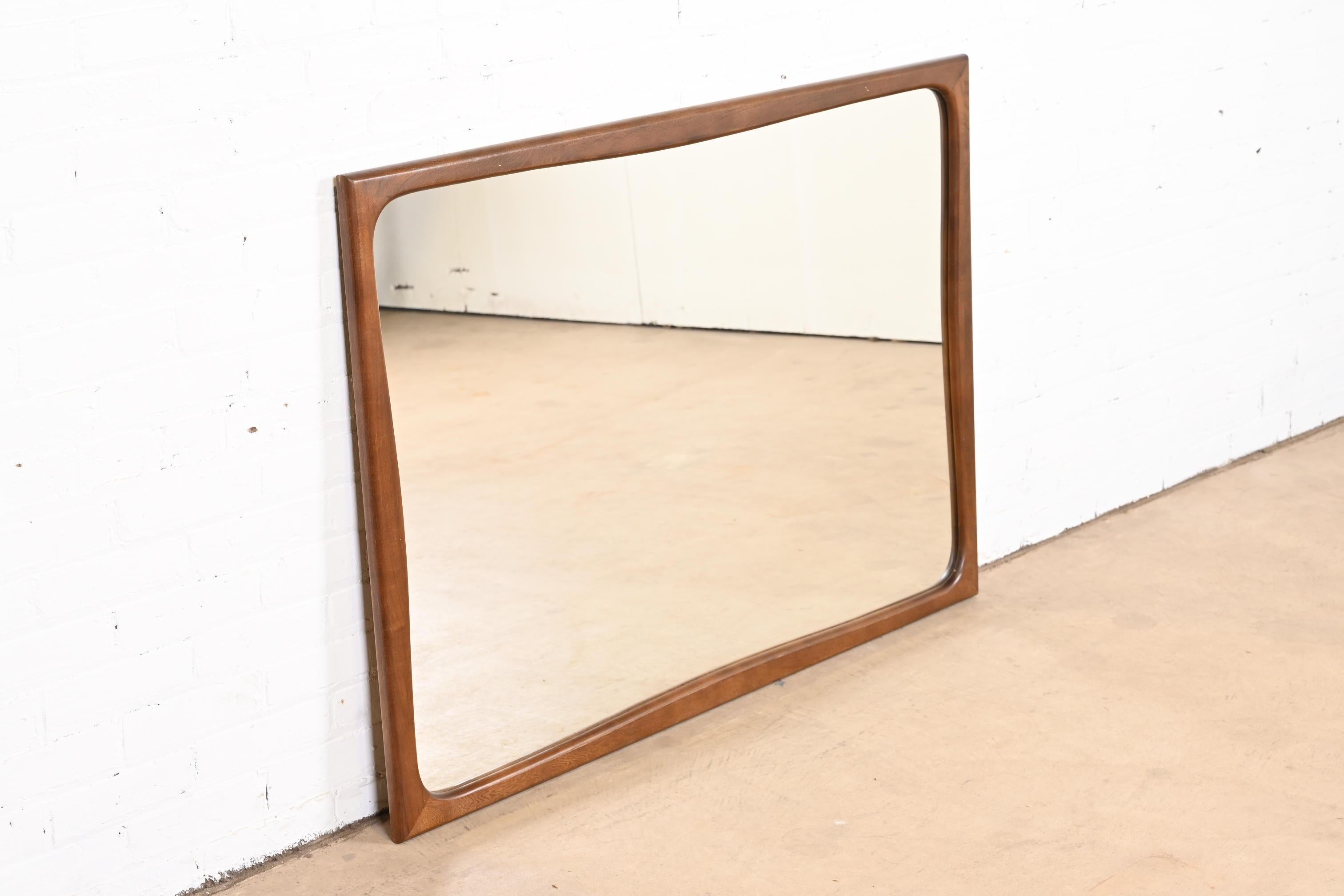 American Mid-Century Modern Sculpted Walnut Framed Wall Mirror