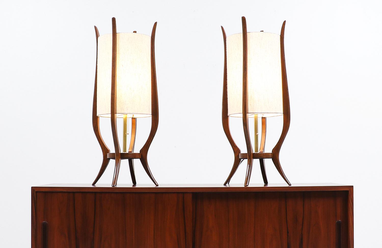 Mid-Century Modern sculpted walnut table lamps.