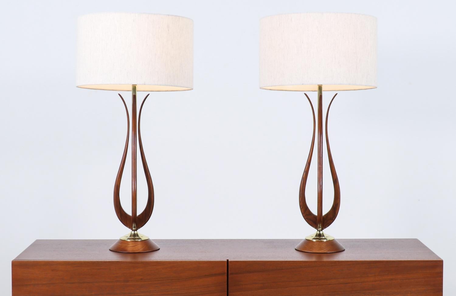 Mid-Century Modern sculpted walnut table lamps with brass accents.

________________________________________

Transforming a piece of Mid-Century Modern furniture is like bringing history back to life, and we take this journey with passion and