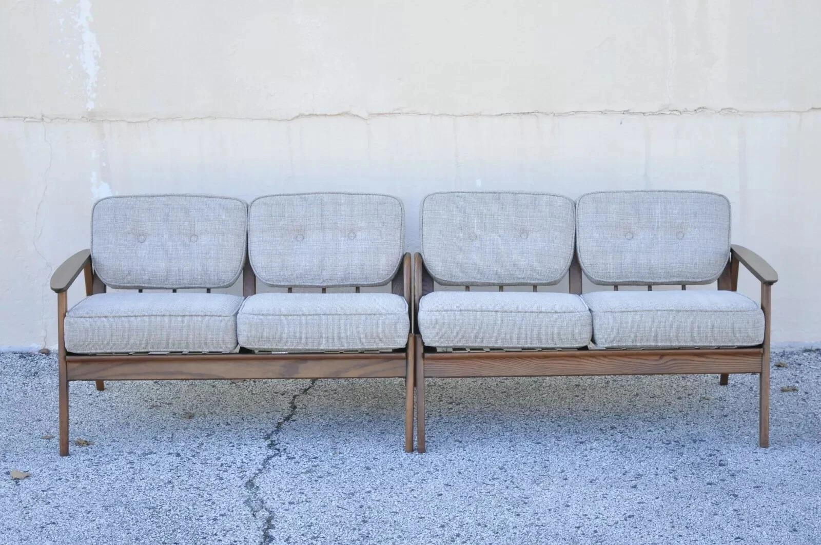 Vintage Mid Century Modern Sculpted Walnut Two Part Four Seat Sectional Sofa - 2 Pieces. Item features oatmeal colored cushions, wood grain laminate armrests, beautiful wood grain, 2 part construction, quality American craftsmanship. Circa Mid 20th
