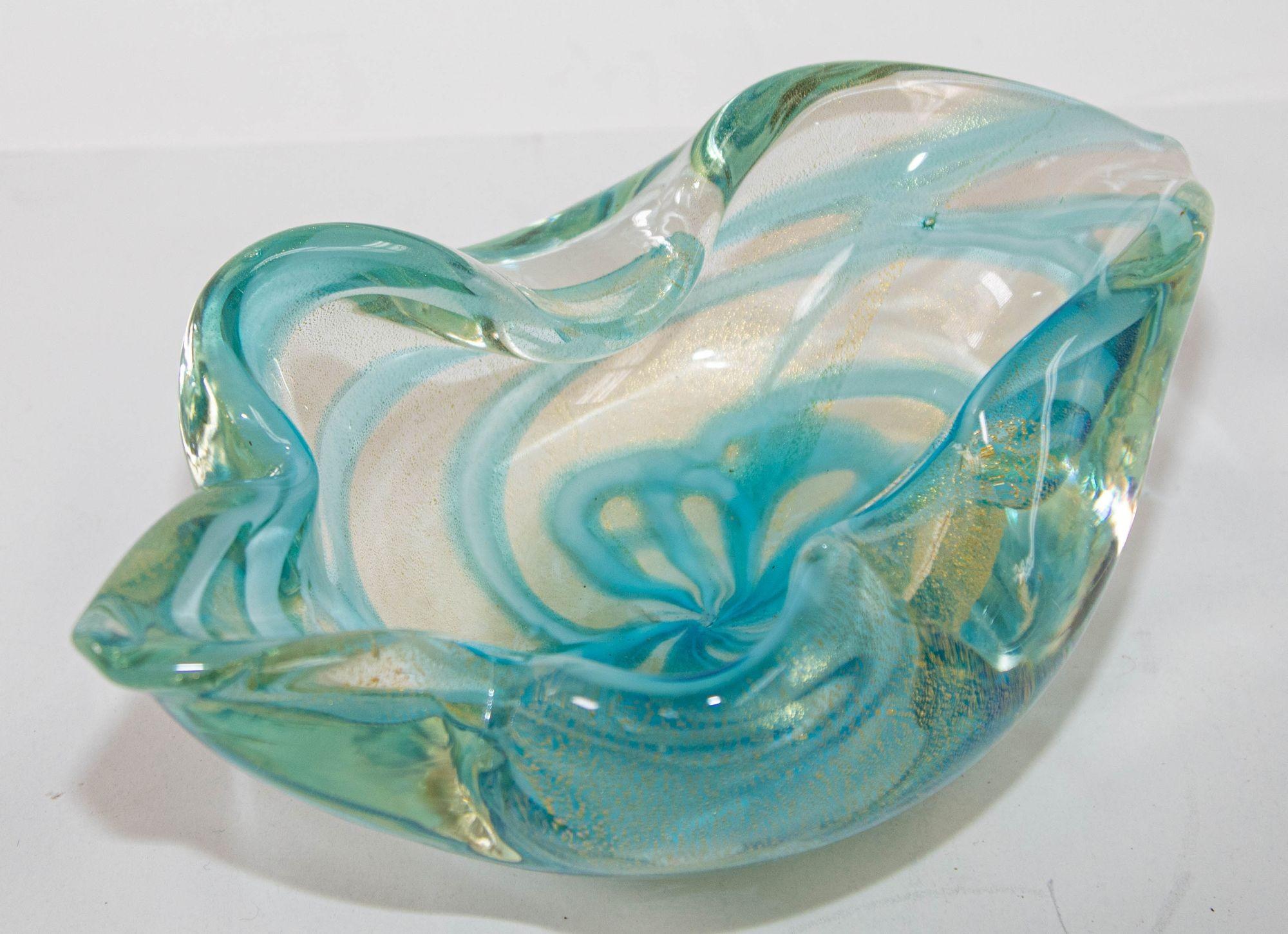 Mid-Century Modern Sculptural Aqua Blue & Gold Hand blown Murano Glass Bowl.
This elegant Mid-Century Modern decorative bowl was realized in Murano, Italy- the island off the coast of Venice renowned for centuries for its superlative glass