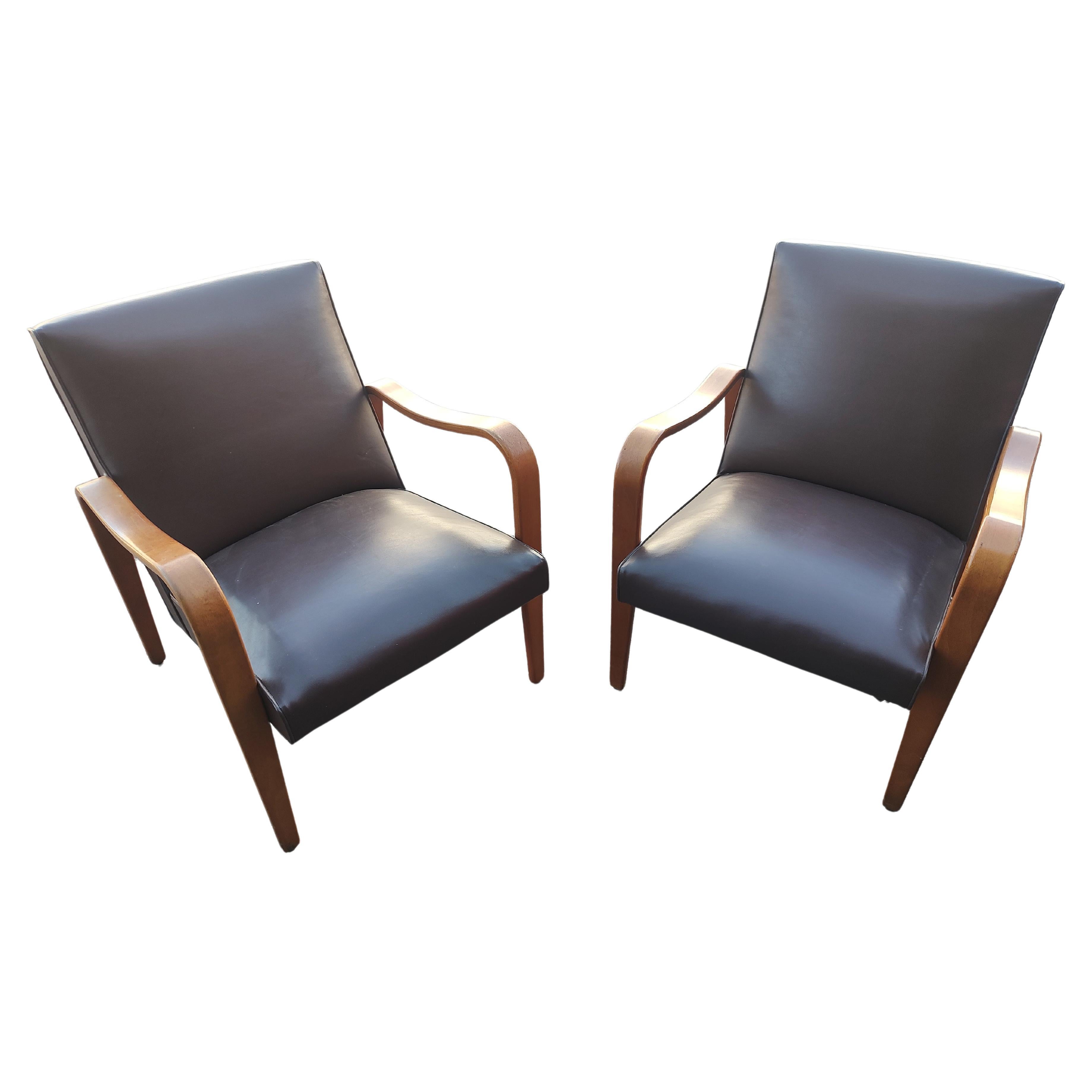 Fabulous pair of Mid Century Modern Sculptural Lounge Chairs by Thonet in Bent arm Birch with the original Naughahyde upholstery. In excellent vintage condition with minimal wear. Some minor paint splatter on one seat. See pic. Priced and sold as a