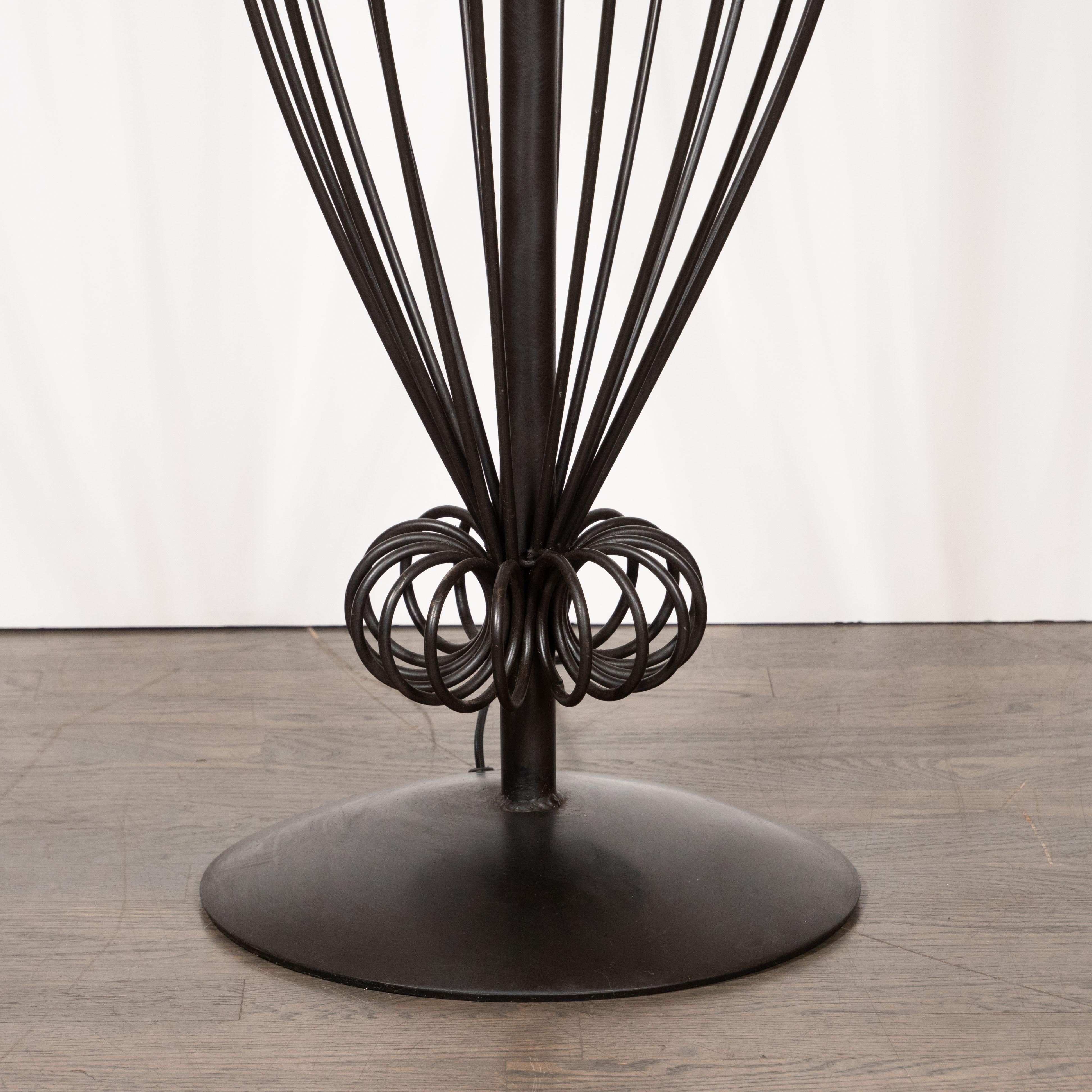 This stunning and dramatic sculptural midcentury floor lamp was realized in America, circa 1960. It features a circular base with a cylindrical rod extending upwards that culminates in a circular cupola of the same form, of a smaller diameter. An