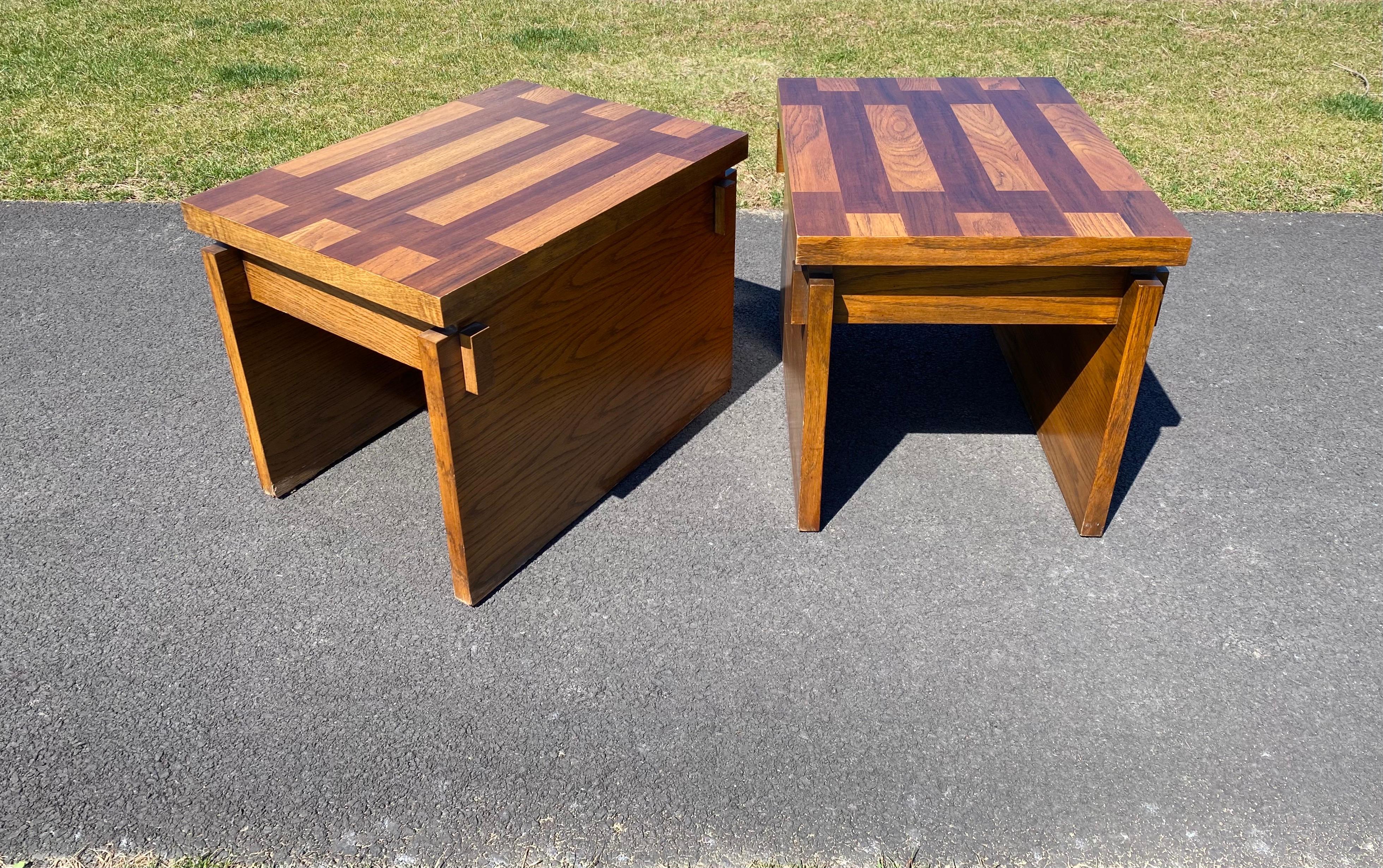Pair of Mid-Century Modern sculptural wood block side or end side tables. Features parquet style table tops and chunky wood sides with decorative exposed mortise and tenon joinery. 

Lane Furniture, marked to underside. 
Circa 1970s.


 