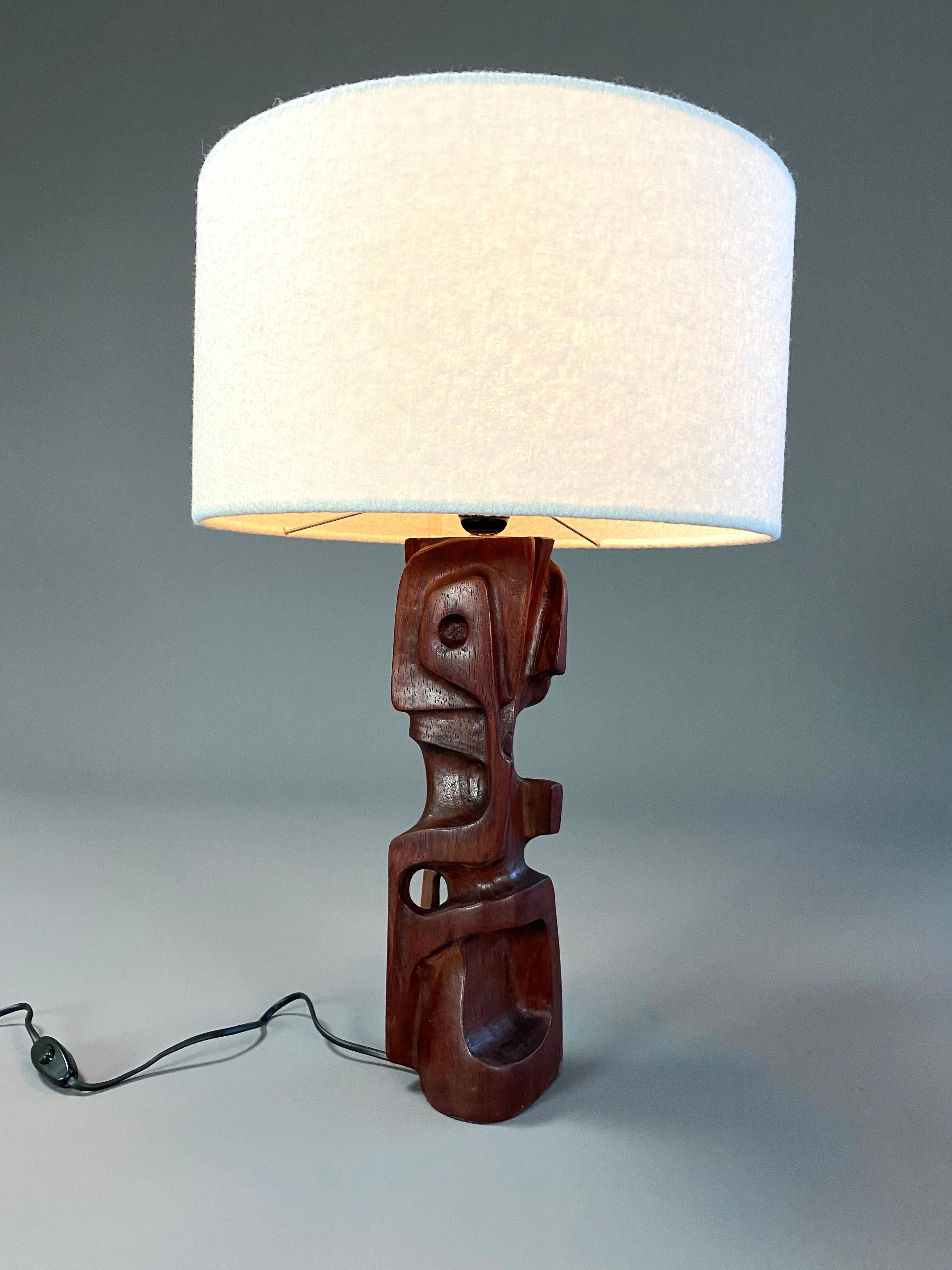 Unique pair of hand carved wooden sculptural table lamps made by Gianni Pinna. The wooden sculptures, lamps, are in great condition. No cracks nor damage. Please note that the two lamps differ slightly in color. One is brownish while the other one