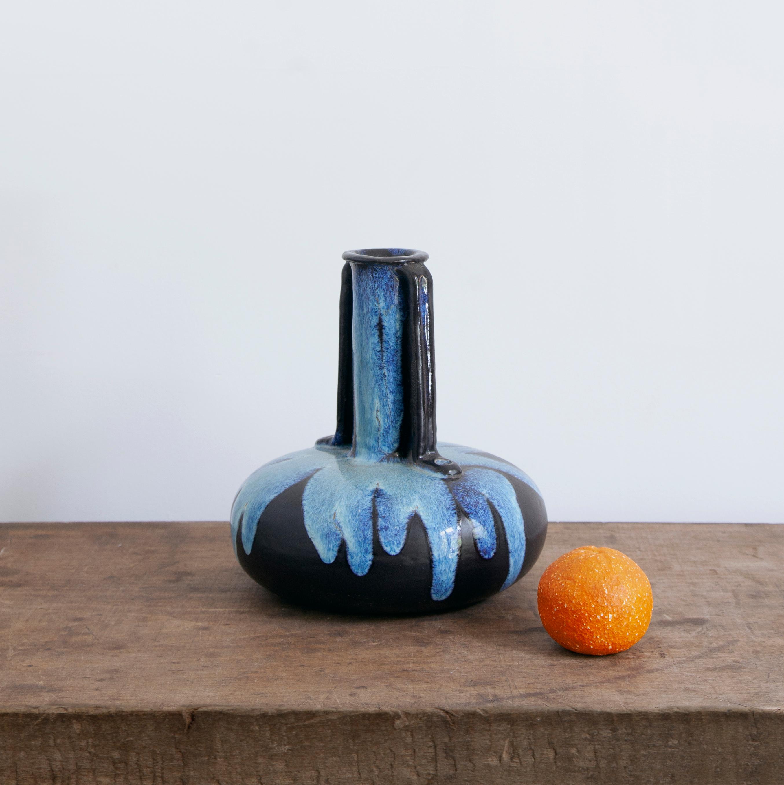 Mid-Century Modern sculptural ceramic vase. Made in Belgium circa 1950, this ceramic vase is decorated with drip glaze. Simple but dramatic form makes this piece an elegant Mid-Century Modern addition to any interior.