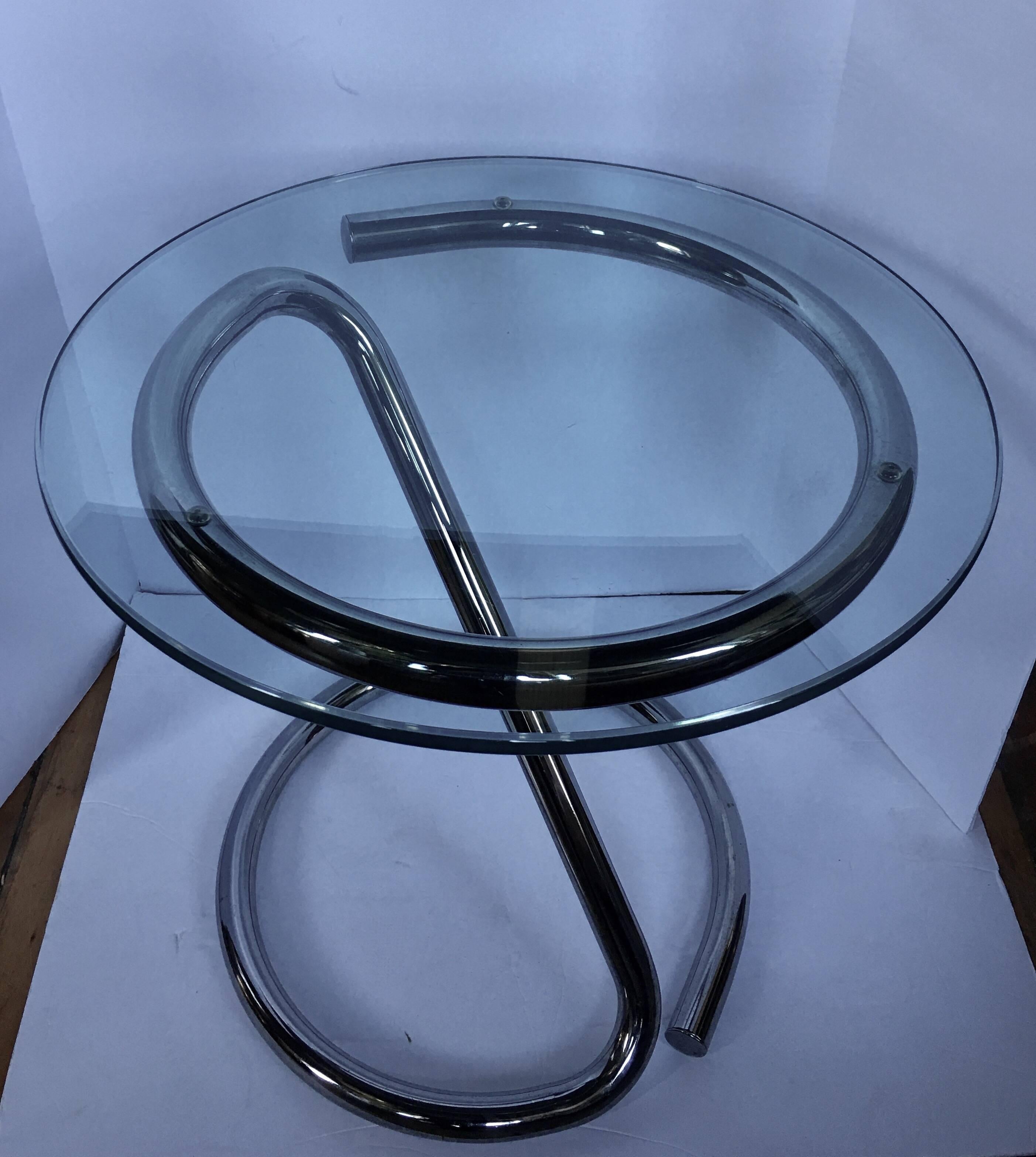 Mid-Century Modern chrome and glass end or accent table featuring a sculptural tubular frame with a removable glass top.