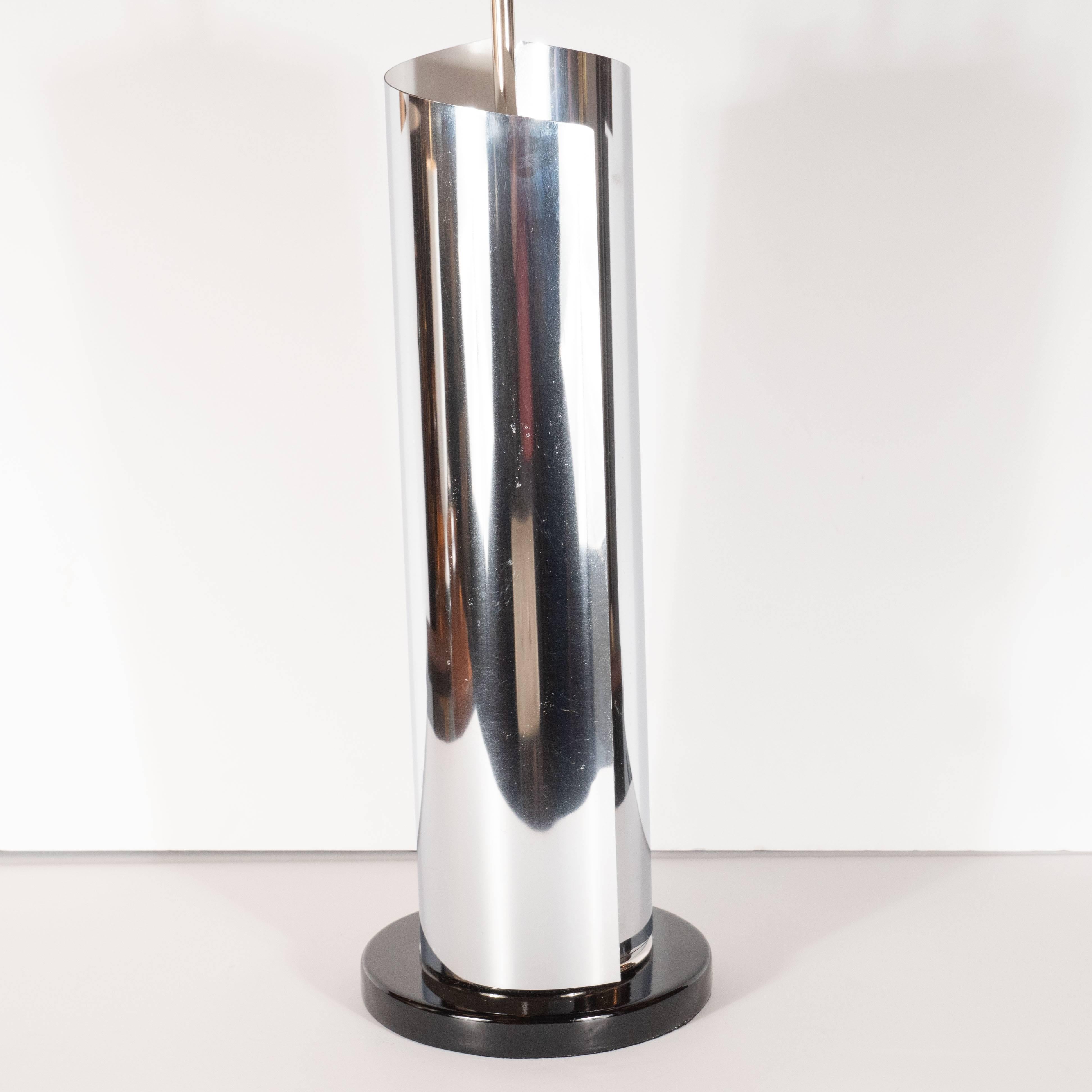 This stunning pair of table lamps were realized in the United States, circa 1970. It features a cylindrical bodies in polished chrome- whose curled forms suggests a miniature Richard Serra sculptures and cream lacquer interiors. They sit on circular