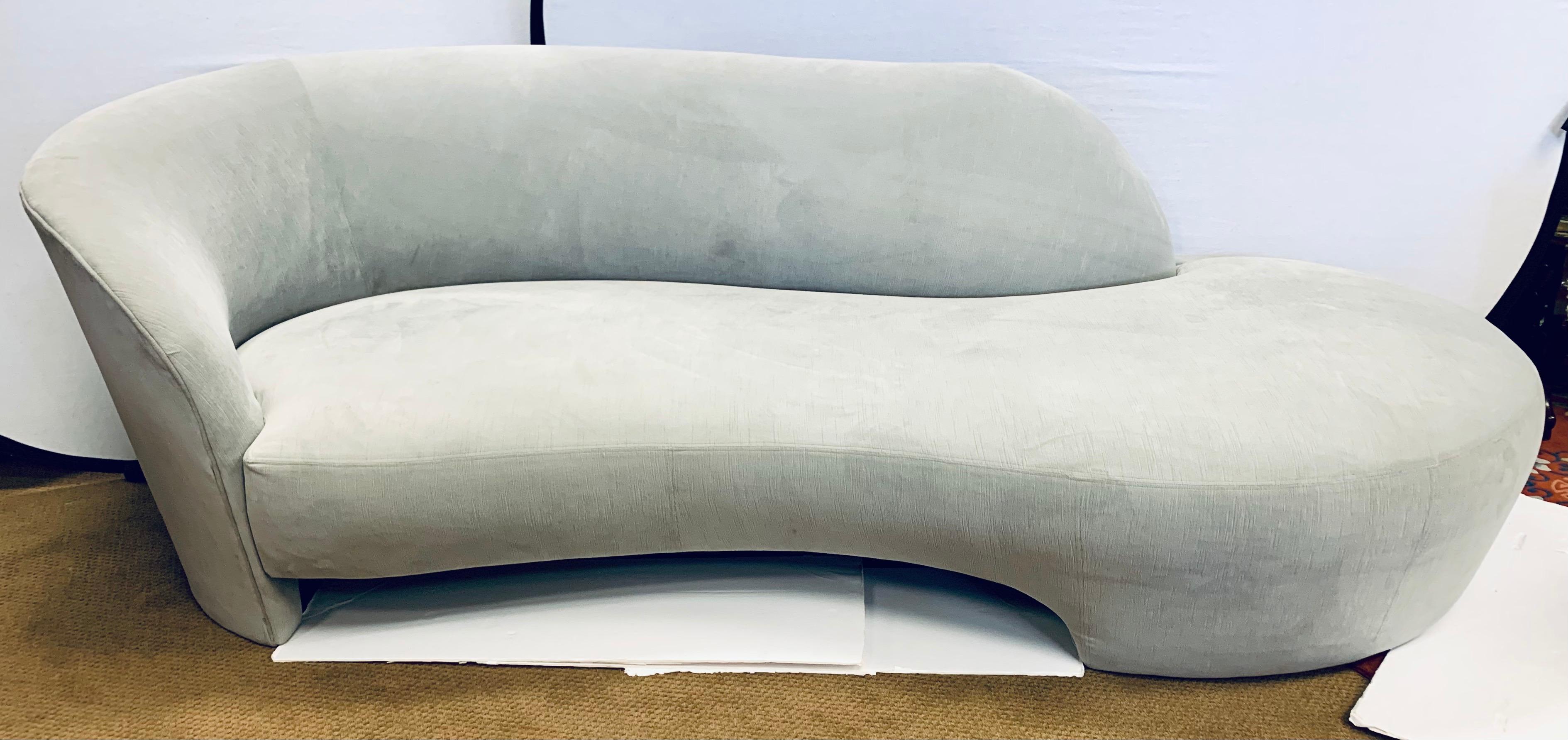 Stunning organic sculptural serpentine sofa with great scale and lines to die for. The luxurious gray velvet fabric is less than two years old and is still in very good condition save for a spot or two - see pics. This sofa will be the most