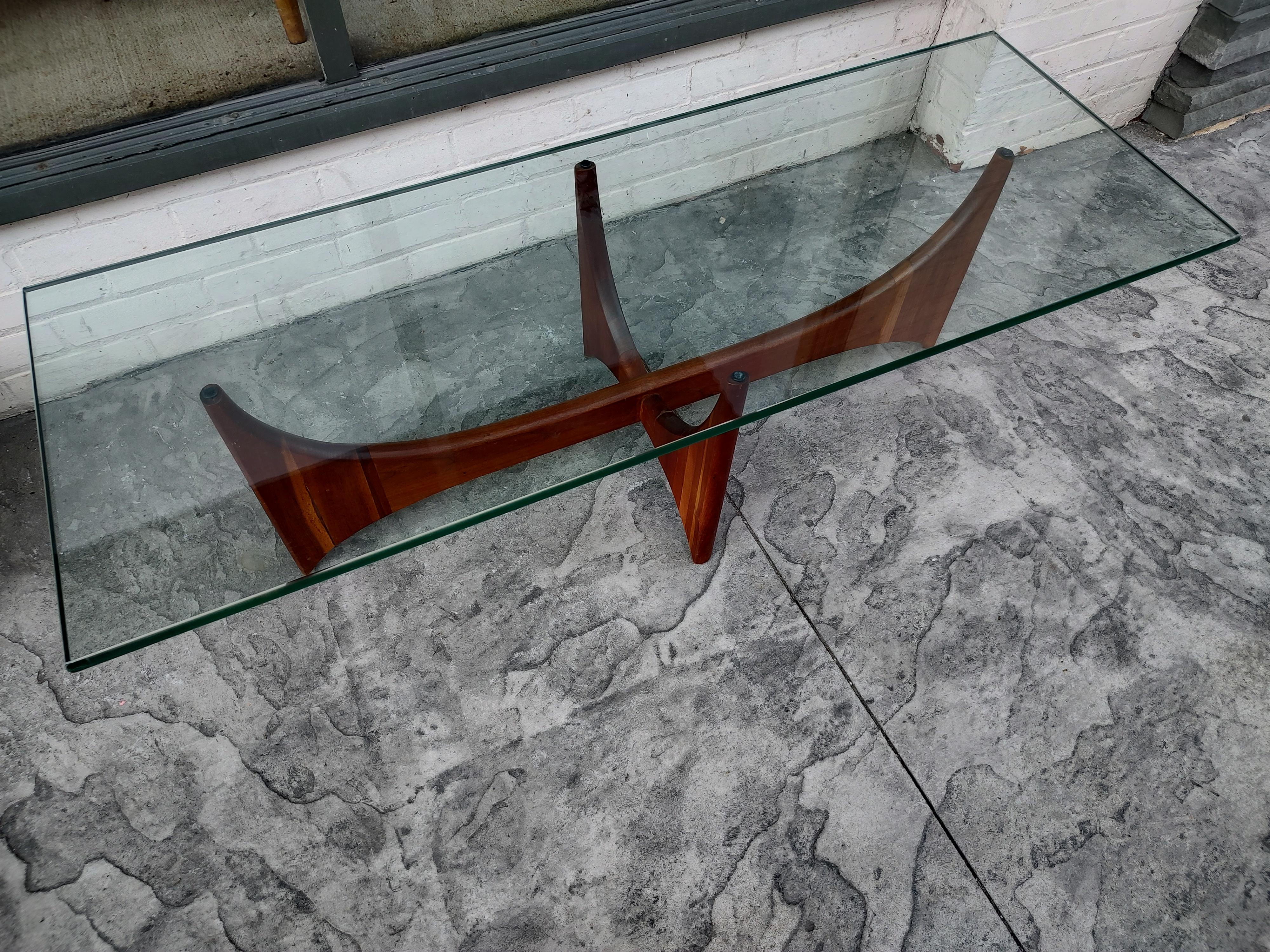 Fabulous sculptural cocktail table by Adrian Pearsall and Craft Associates. Model # 2399-TC. In excellent vintage condition with minimal wear. Walnut in very good condition retaining the original floor glides and bumpers for the glass top.