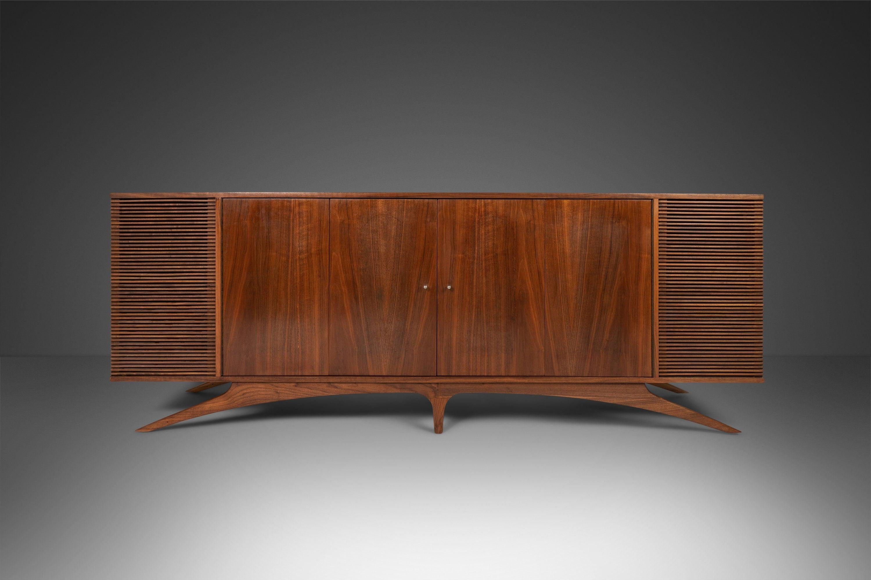 As functional as it is visually stunning this extraordinary stereo cabinet is the epitome of 'functional art'. Constructed of a mix of solid and veneered walnut with exceptional old-growth woodgrains this sideboard is unlike any other we've ever