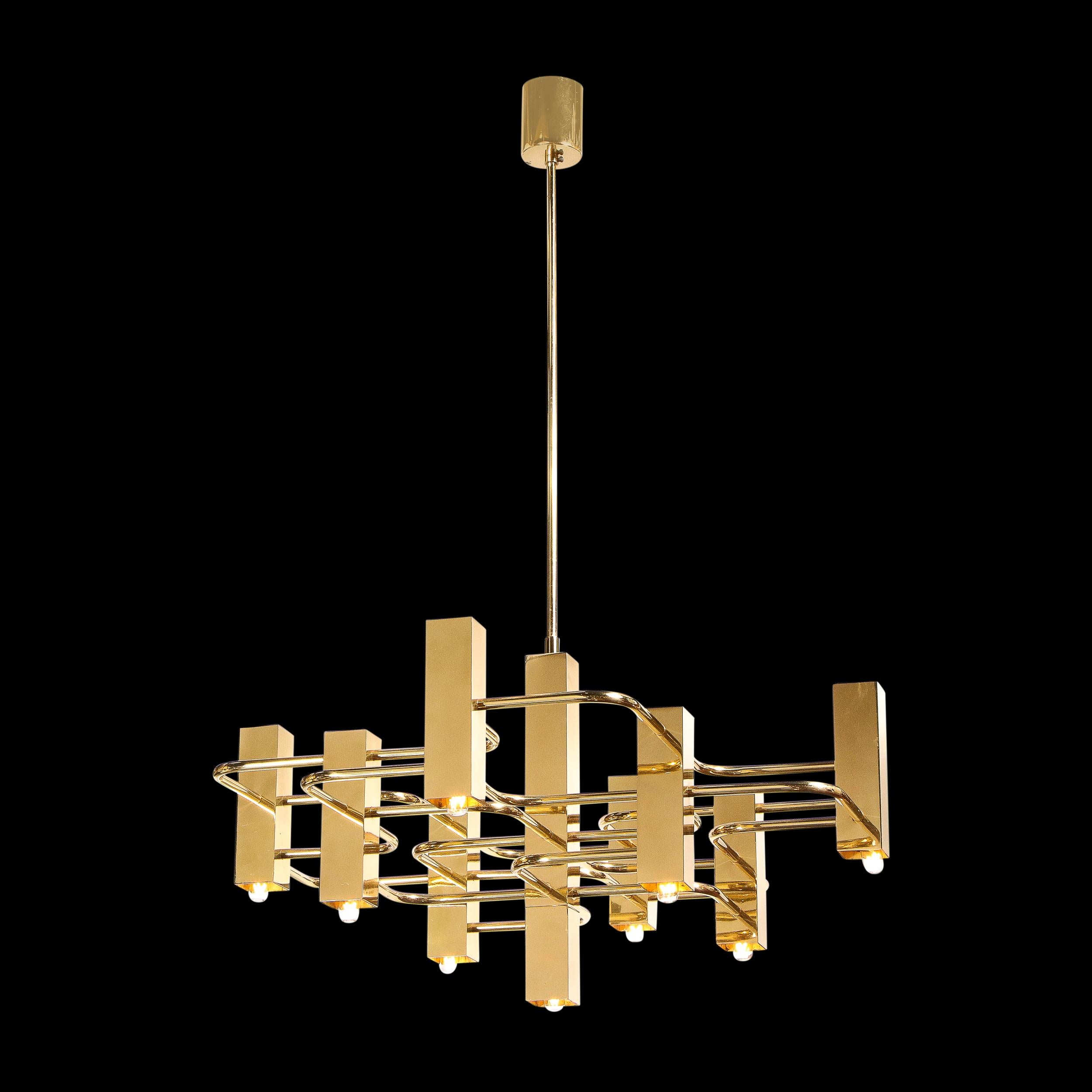 This stunning polished brass chandelier was realized in 1970s by famed lighting designer, Gaetano Sciolari. His designs were in high demand which made a considerable contribution to the success of the Italian design around the world, particularly