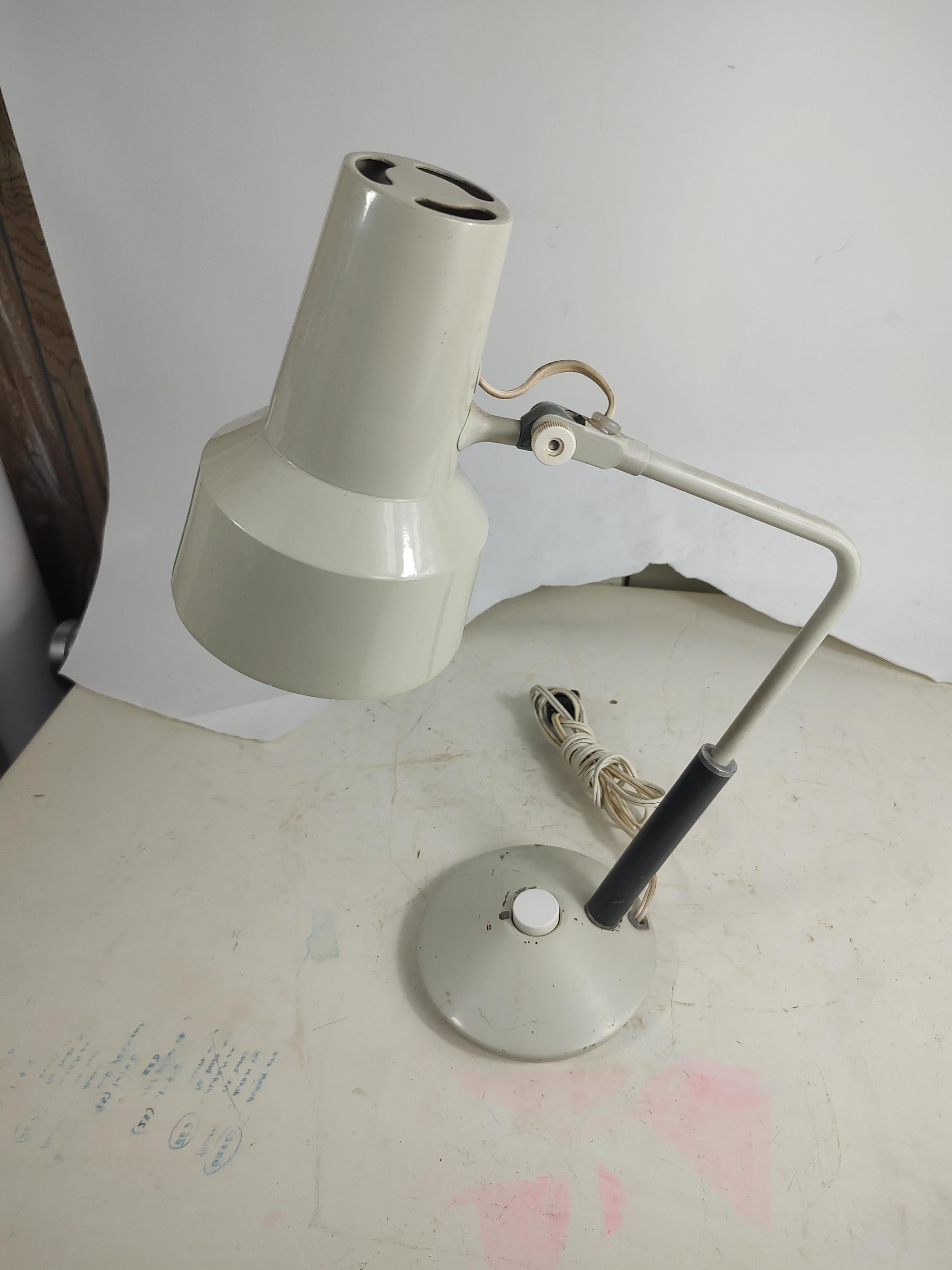 Diminutive table desk lamp in white by Luxo. Fully adjustable. Designed by Jack Jacobsen. In very good condition with minimal wear. See pics.