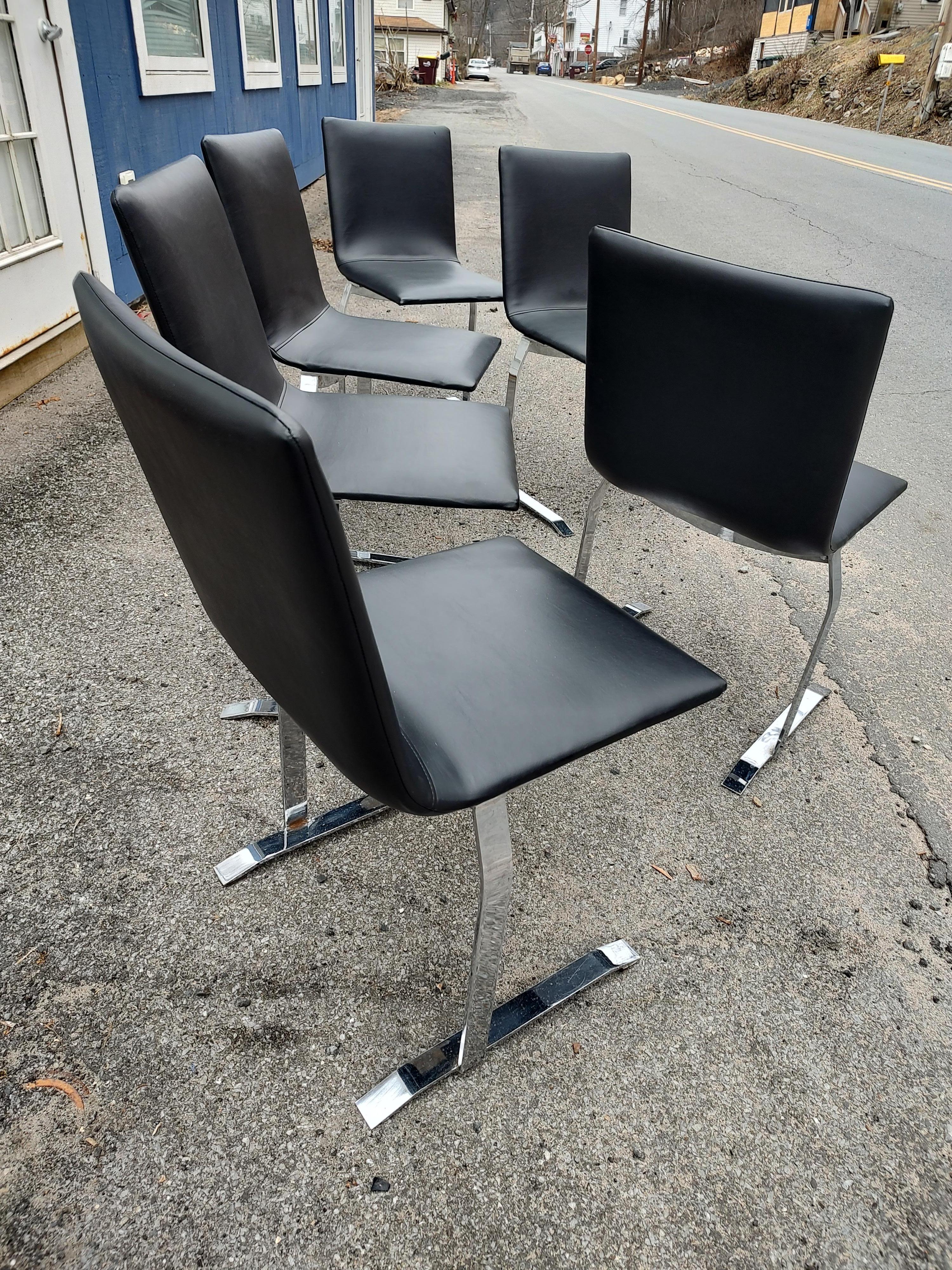Fabulous set of six Saporiti dining chairs in a cantilevered design newy upholstered in commercial grade black vinyl. Beautiful stitching throughout. Chrome is with some wear but no flaking , will be polished out before being shipped. Sold as a set