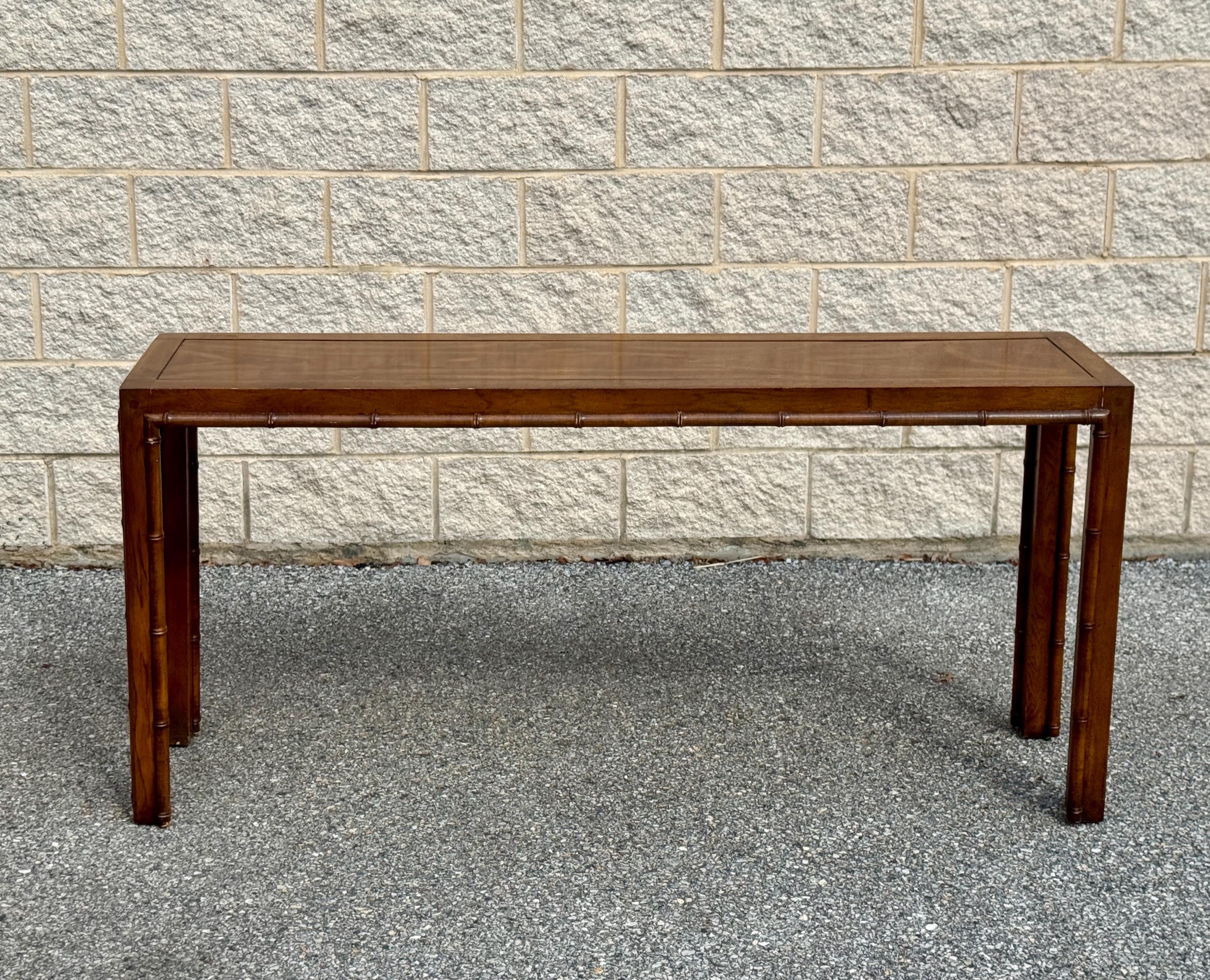 Mid-century modern console table featuring a sculptural silhouette with finely fluted wood details. Beautifully crafted with warm-toned wood that showcases natural grain and texture.