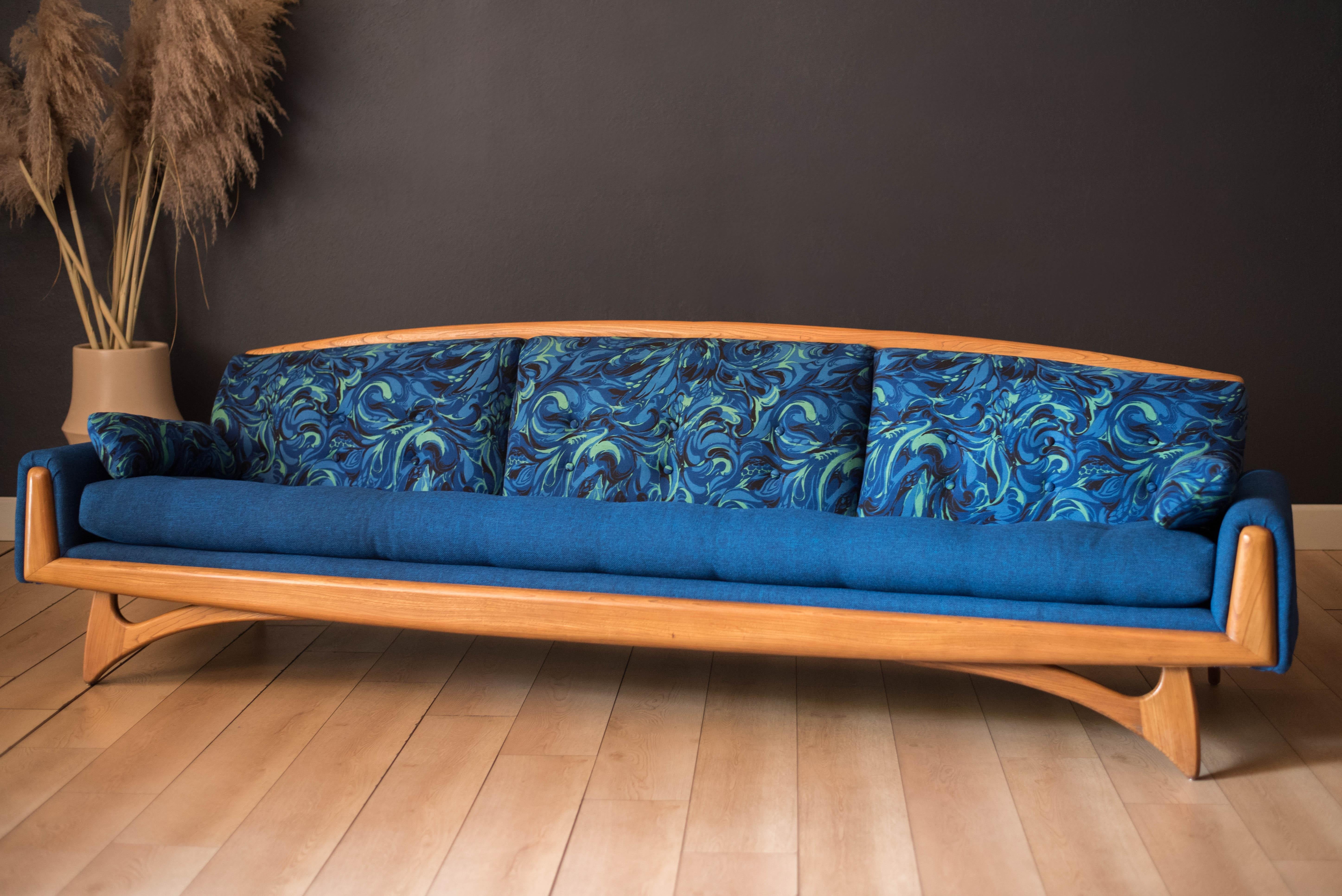 Vintage Sculptural Blue Gondola Sofa manufactured by Kroehler circa 1960's. This standout piece features boomerang legs and classic mid century biscuit tufted cushions. Backrest pillow support is kept original to the piece. 