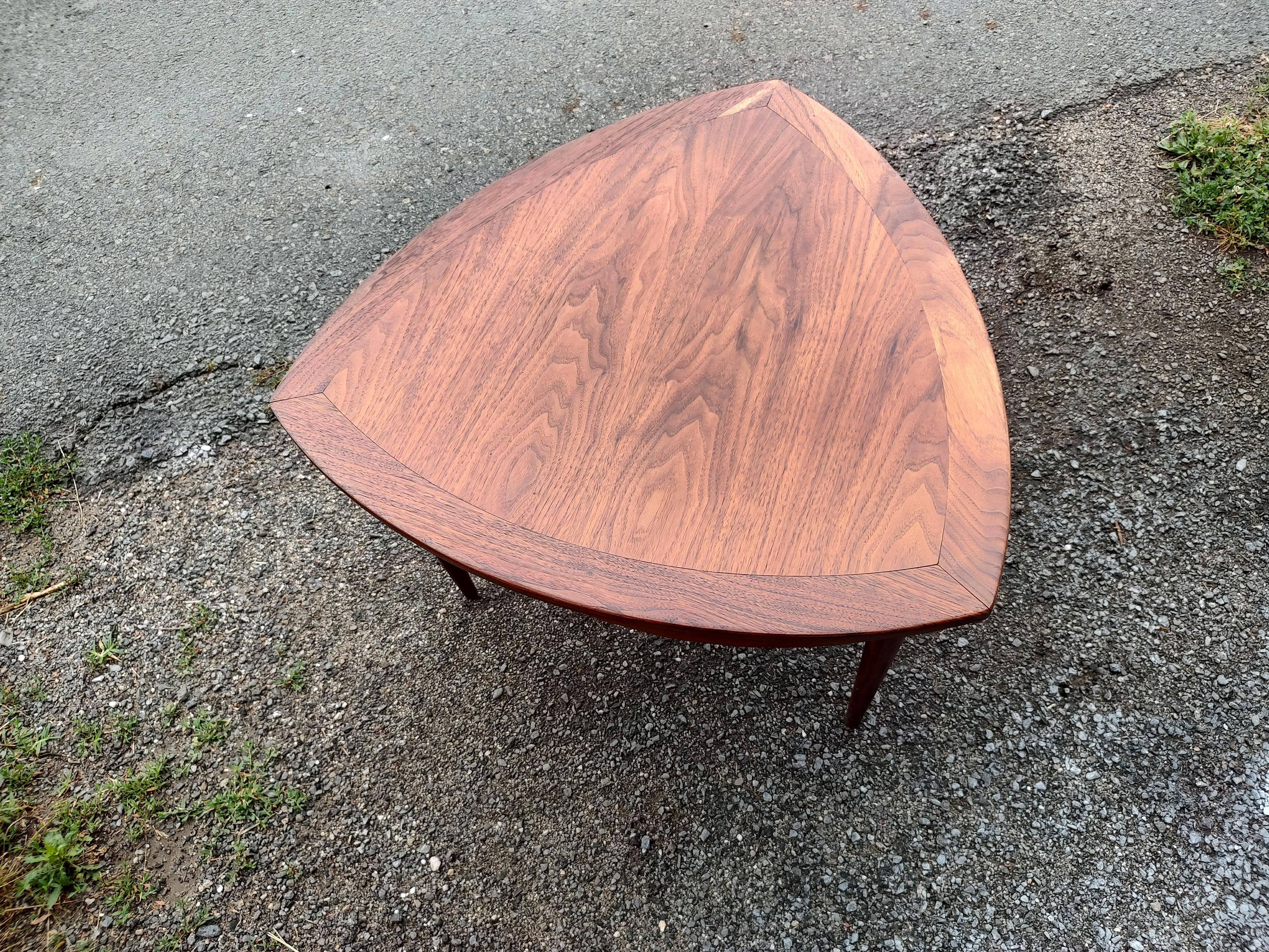 Simple and elegant cocktail table or a large side table. Measures: height is 20.25, width is 27.5. solid walnut with a shelf below for storage. Banded edge and turned legs. In excellent vintage condition with minimal wear.