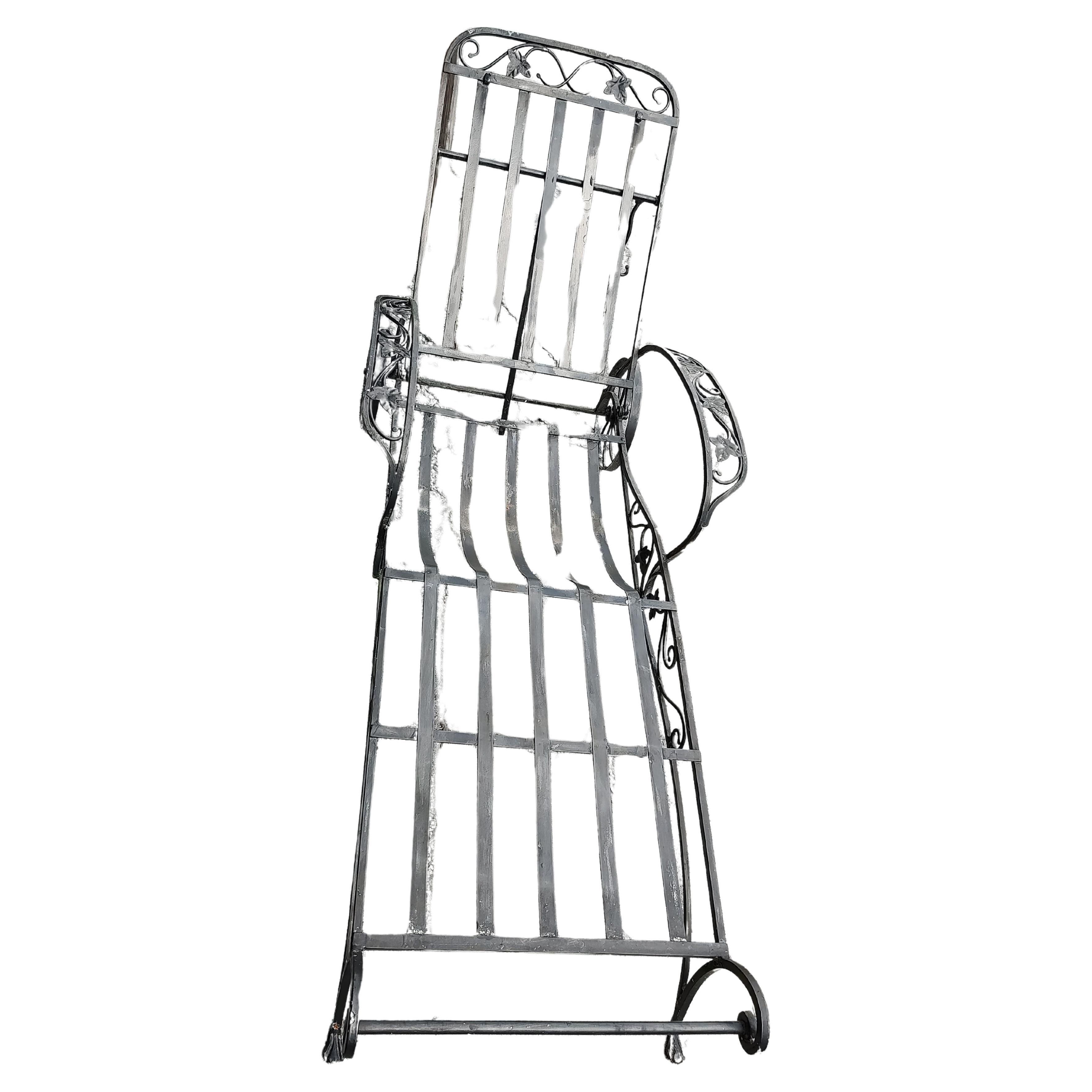 Fabulous hand crafted iron outdoor chaise lounge reclining chair, 5 positions. Has a sunbrella cushion, vintage. Leaf and vine pattern on arms sides and back. In excellent vintage condition with minimal wear. Wheels do not turn.
