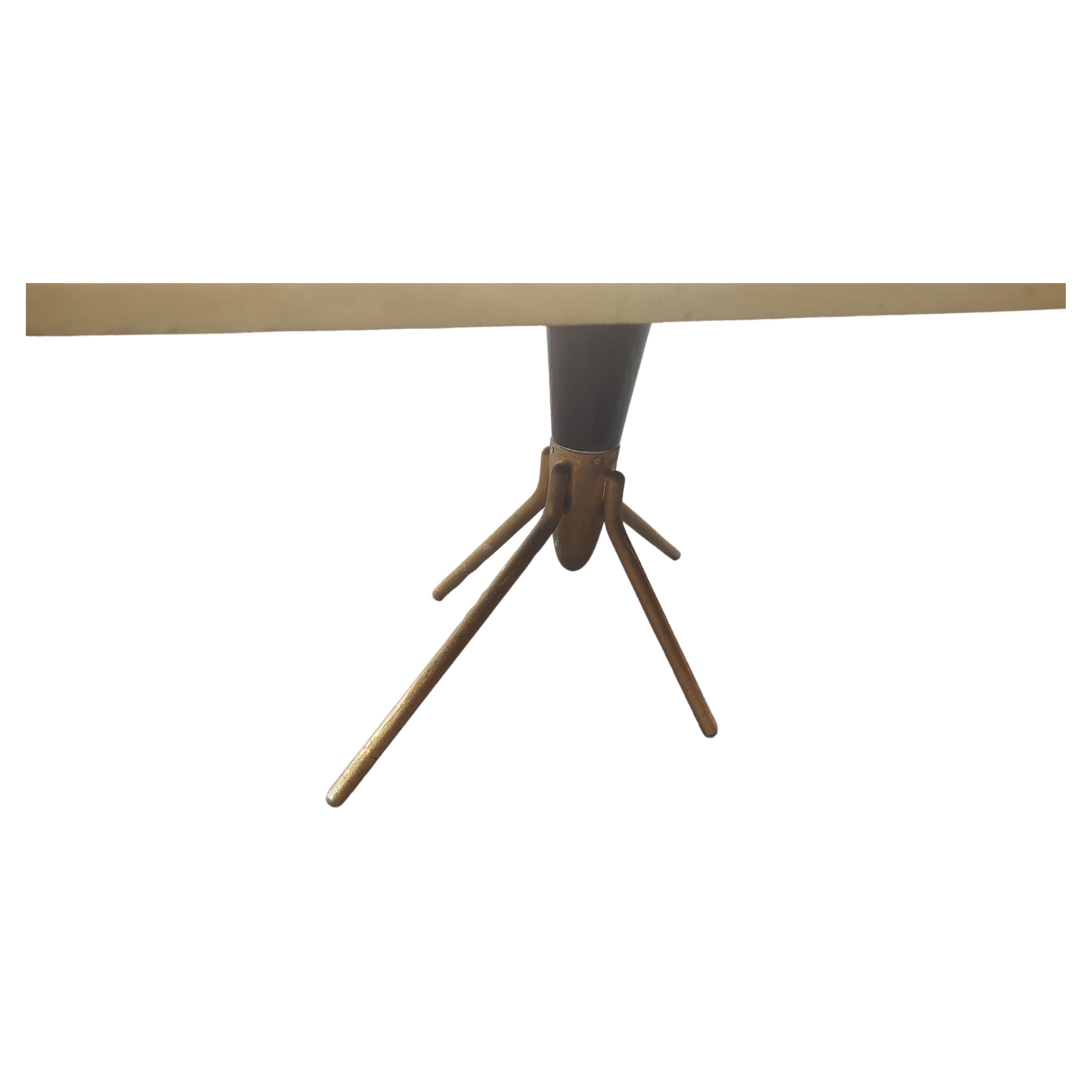 Fantastic petite cocktail table by Aldo Tura with a lacquered parchment top and a space age sprocket type base which is Gilt. 32 x 14 x 14 h so it can work as a side table as well. In excellent vintage condition with minimal wear. 
