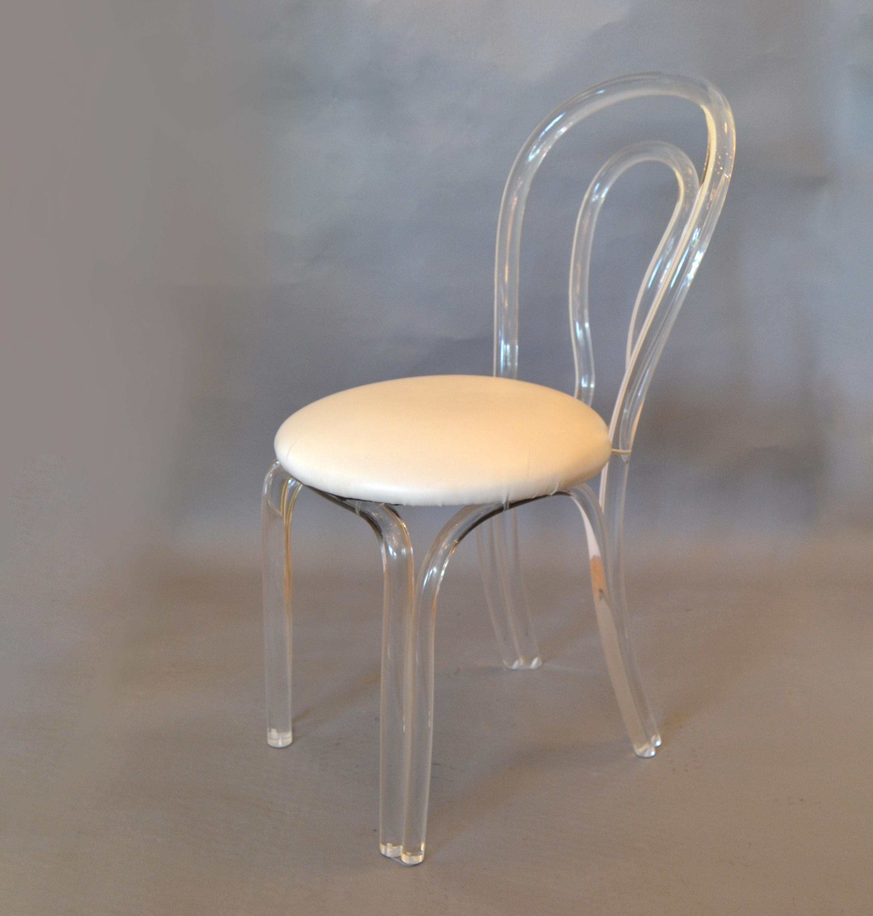Mid-Century Modern sculptural Lucite chair in vinyl upholstery.
The chair has a very unique backrest and base.
Makers Mark underneath the seat.
Can be used as a desk chair or a vanity chair.