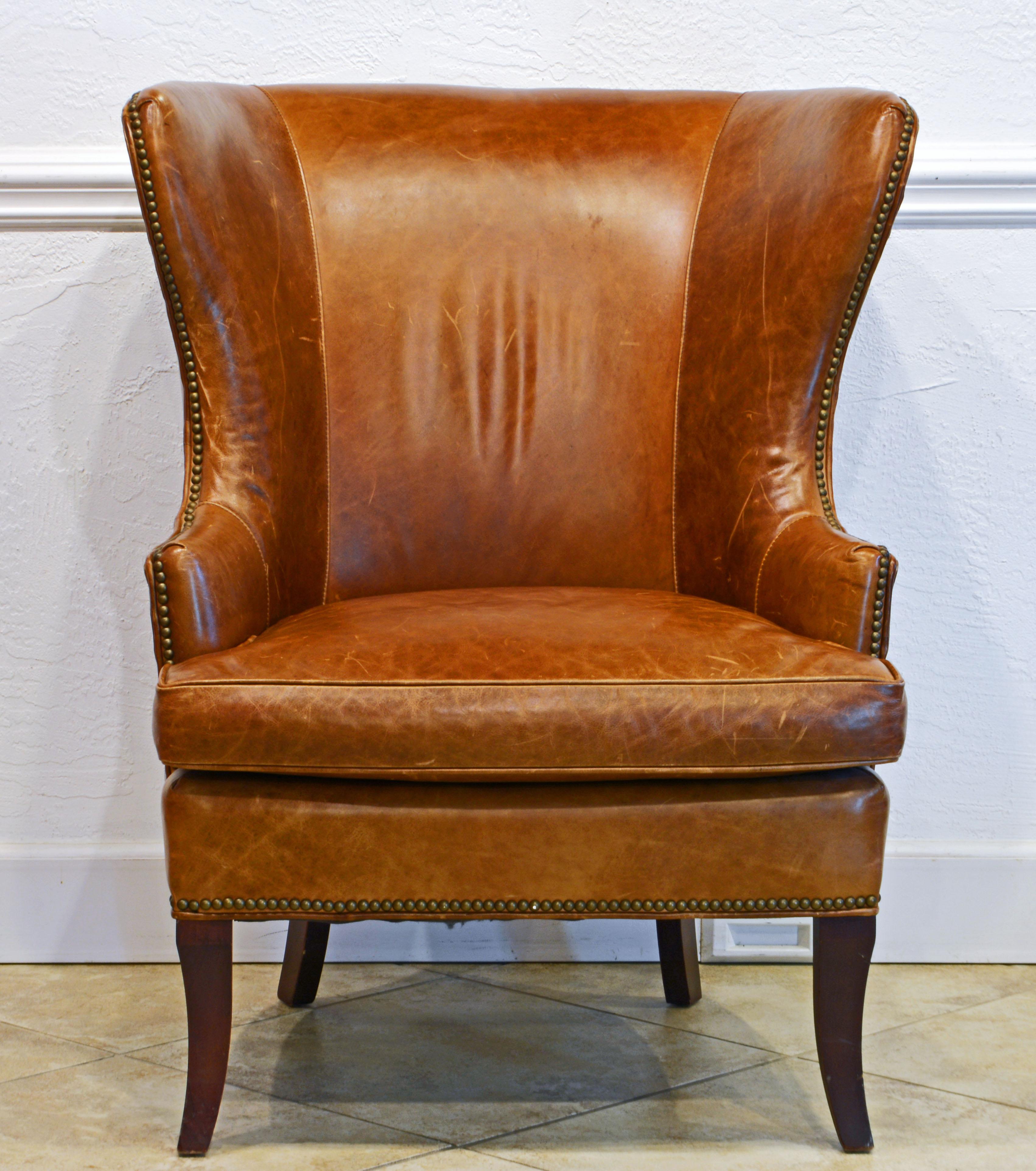 This welcoming wingback leather chair is a modern take on the traditional English Wingback chairs dating back to the time of Queen Anne. The discrete nail head trim accentuates the great lines of the chair. It is a very comfortable chair and the