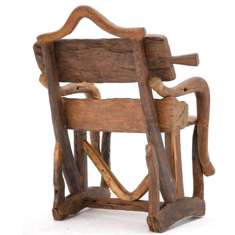 Mid-20th century sculptural armchair. Composed of remains of ancient farming implements. Handmade of olive wood and walnut, France, 1940s.



             