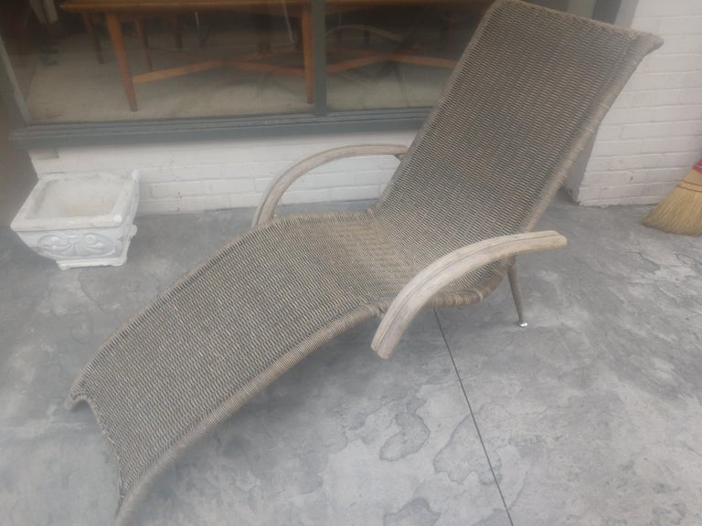 Fabulous sculptural rattan chaise lounge chair attributed to Franco Albini. Rattan is tightly woven over a brass plated steel frame. Very strong and rigid frame. In excellent vintage condition with minimal wear. Rattan has darkened with age.