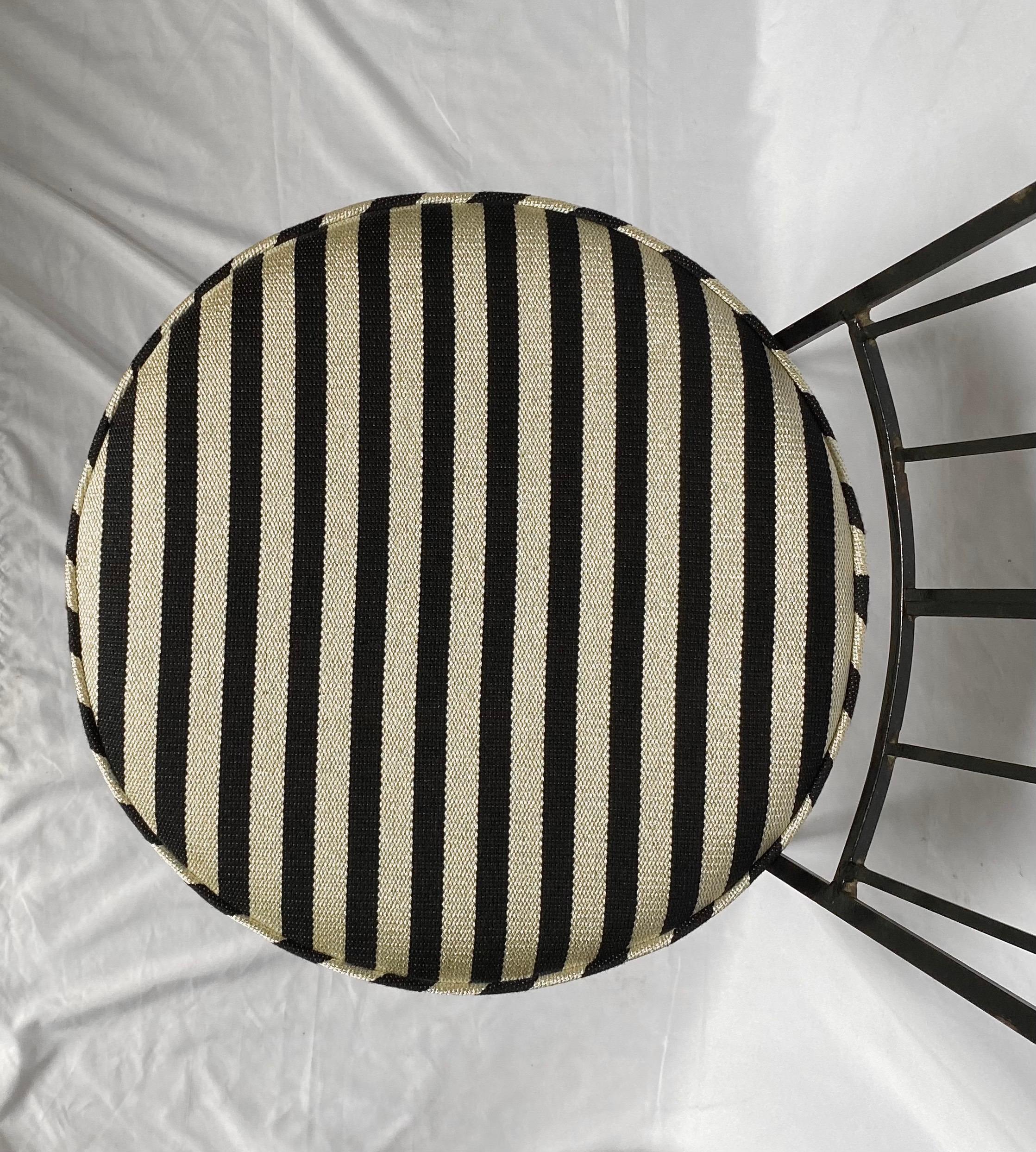 Mid-Century Modern matte black metal wrought iron chair newly upholstered in a Schumacher black and tan stripe inspired by Geoffrey Beene. This stylish accent chair features a sculptural arched patterned back with angular curved legs. Graphic