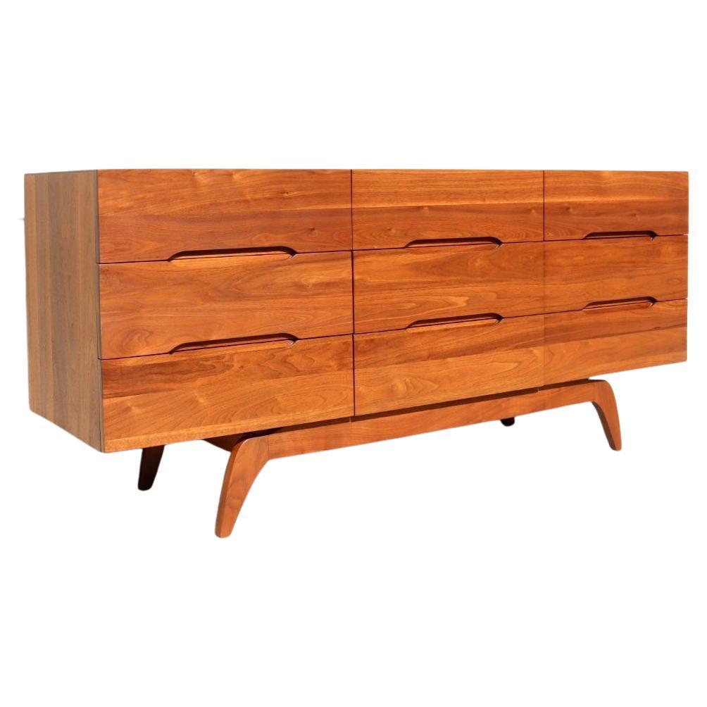 We have restored this stunning Mid-Century Modern sculpted solid walnut dresser to excellent vintage condition. 

This is a very special case piece. It is an absolutely stunning solid walnut dresser. It is extremely rare to find a case piece that is