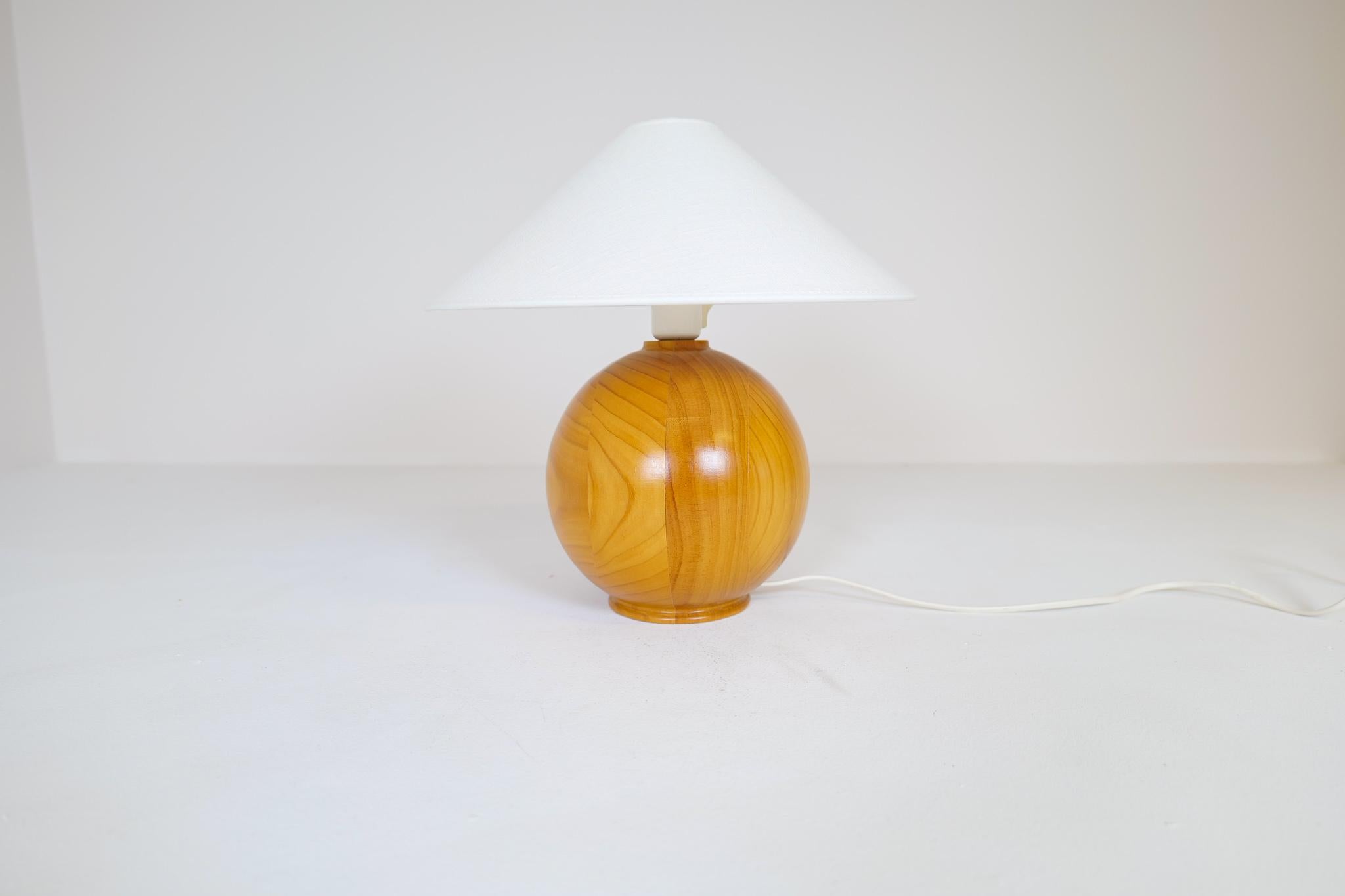 A nice-looking table lamp made with rounded solid pine. 

Good working vintage condition, with wear consistent with age and use. New shade is included. 

Dimensions: Heigh with shade 38 cm base diameter Shade 35 cm. The lamp height 30 cm and 19
