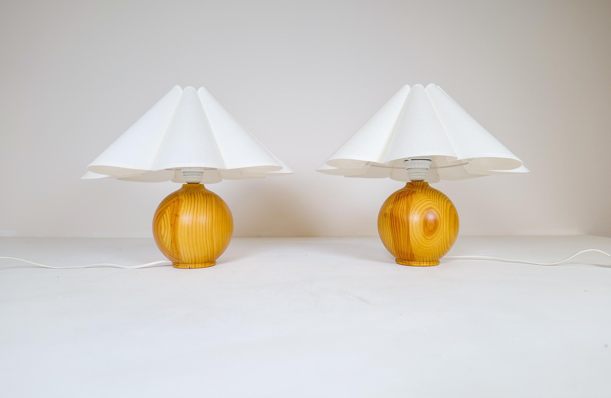 Wonderful, sculptured table lamps made with rounded solid grained pine. The globe grained pine working well with the all-new high-quality shades produced in Sweden.

Good working vintage condition, with wear consistent with age and use. New shade
