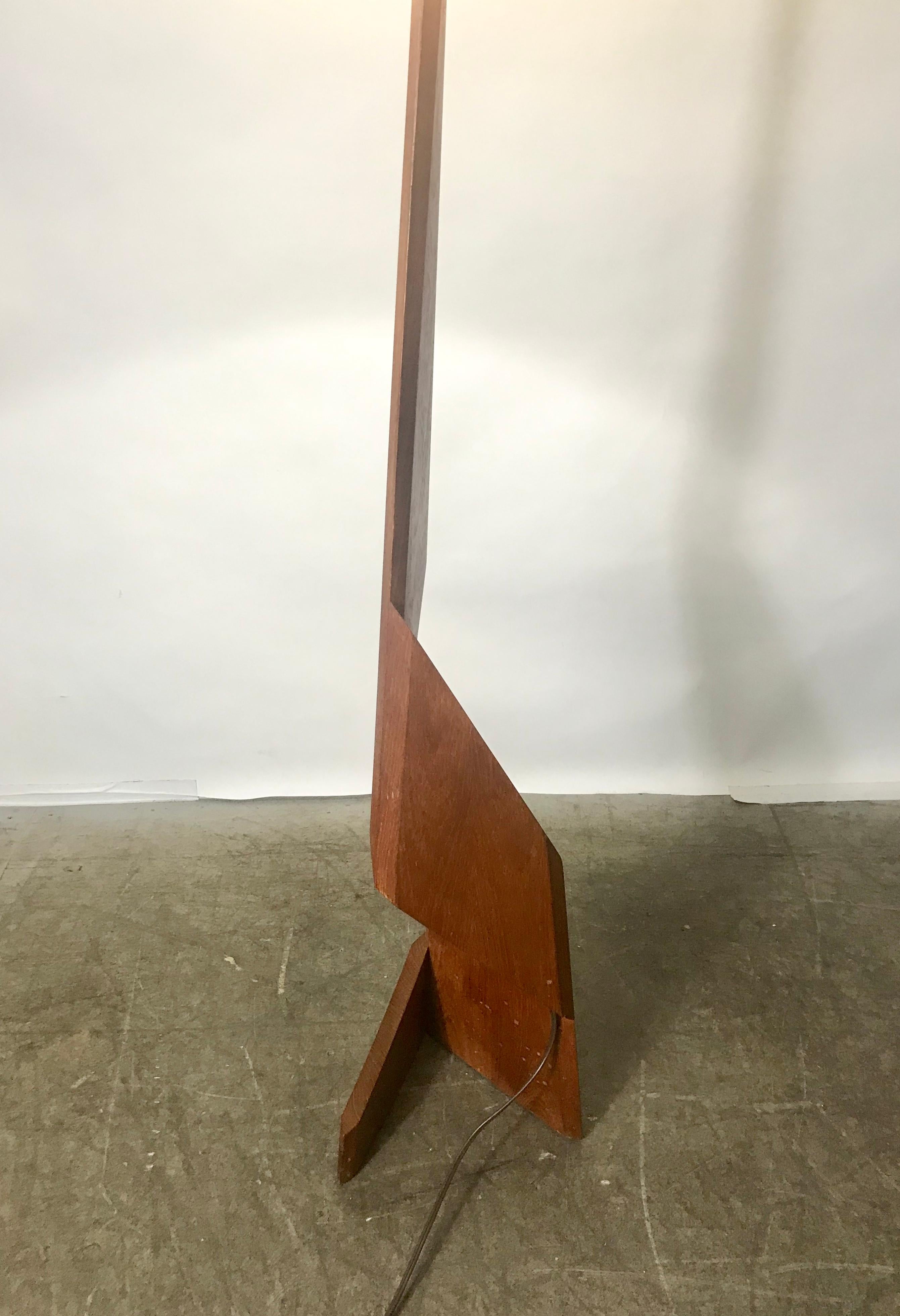 A uniquely designed Zig Zag teak floor lamp from the 1960s Danish Mid-Century Modern era. Amazing craftsmanship throughout featuring a sculpted geometrical solid teak base with original shade.