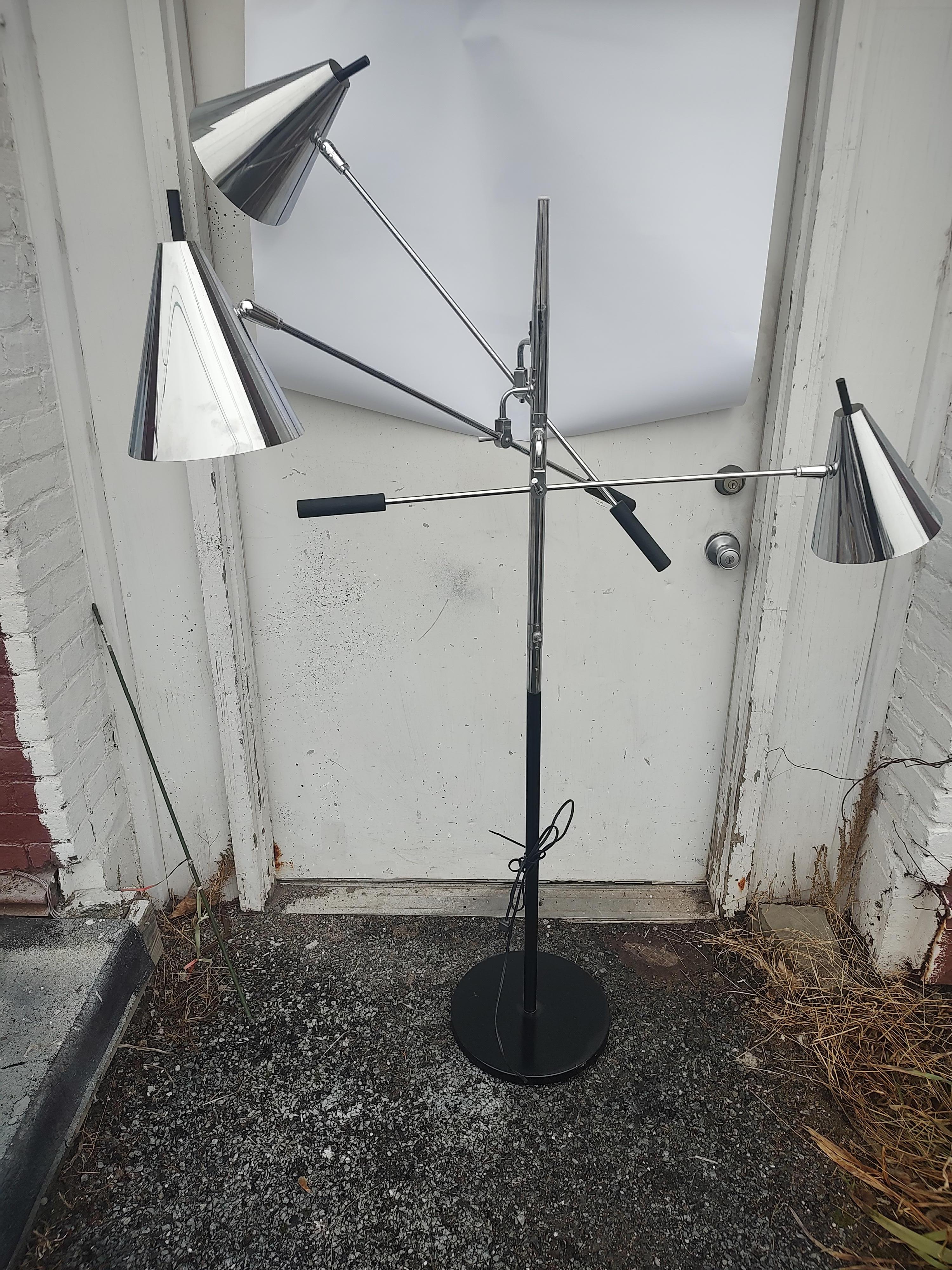 Spectacular period mid century modern design of a triennial lamp in nickel plated chrome with a heavy weighted black base and accents. Attributed to  Gino Sarfatti lighting designer who has created many iconic lamps. This particular piece is a real