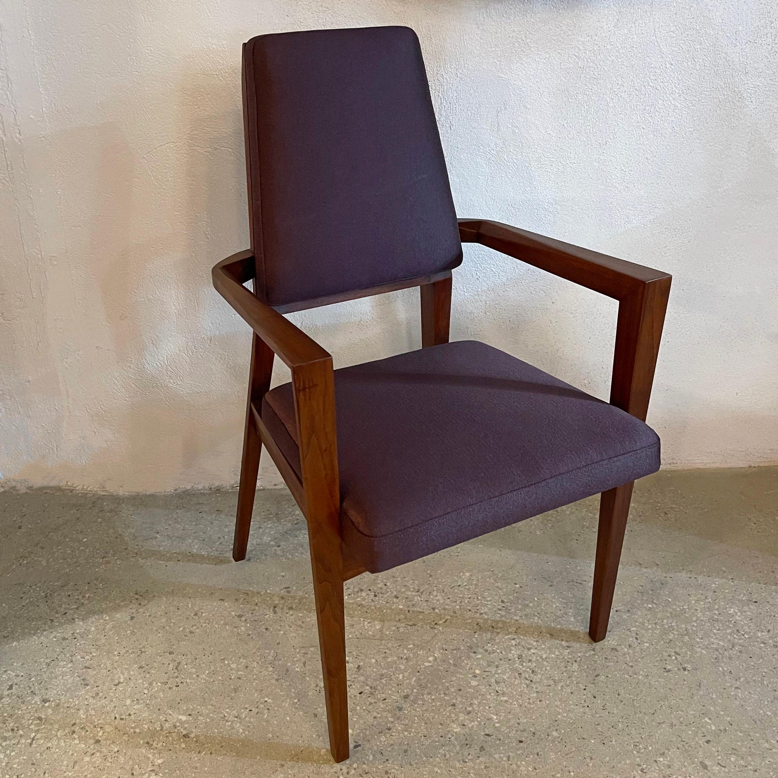 Stately, mid-century modern armchair by Marc Berge for Grosfeld House features a sculptural walnut frame with patterned beveled edges throughout. The seat and back are newly upholstered in deep, rich aubergine linen with a slight sheen to the