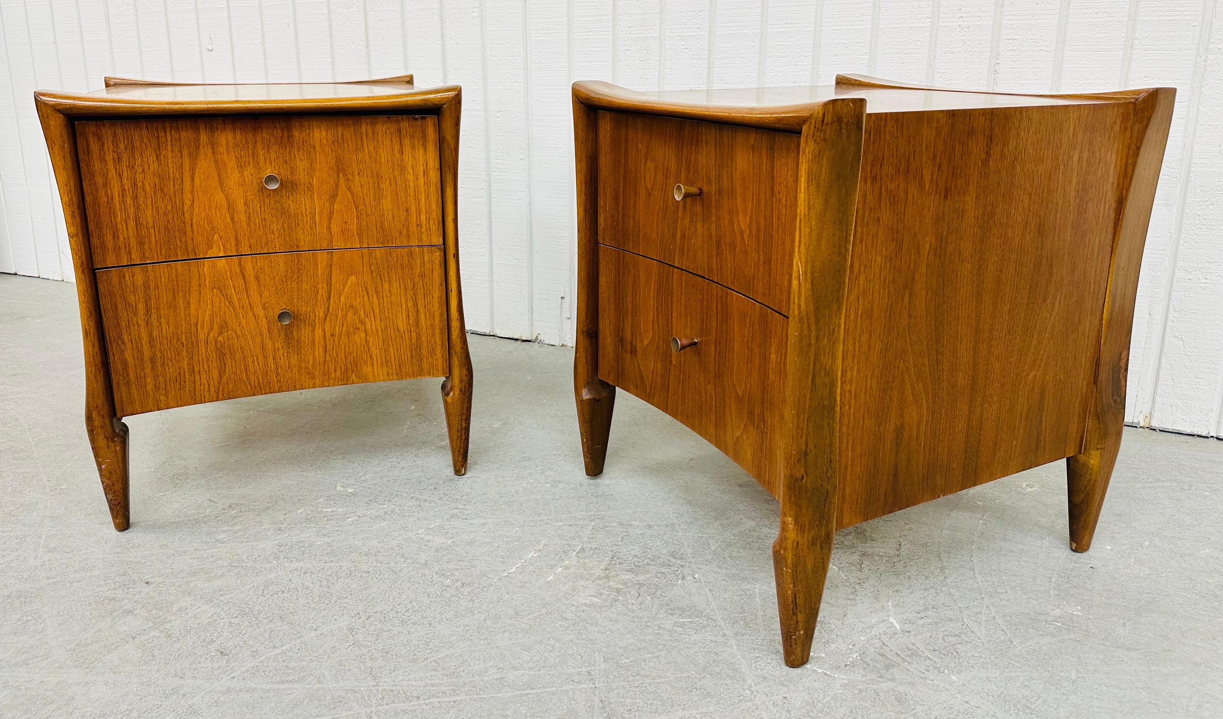 This listing is for a pair of Mid-Century Modern Sculptural Walnut Nightstands. Featuring a straight line design, two drawers for storage, original hardware, and a beautiful walnut finish. This is an exceptional combination of quality and design!