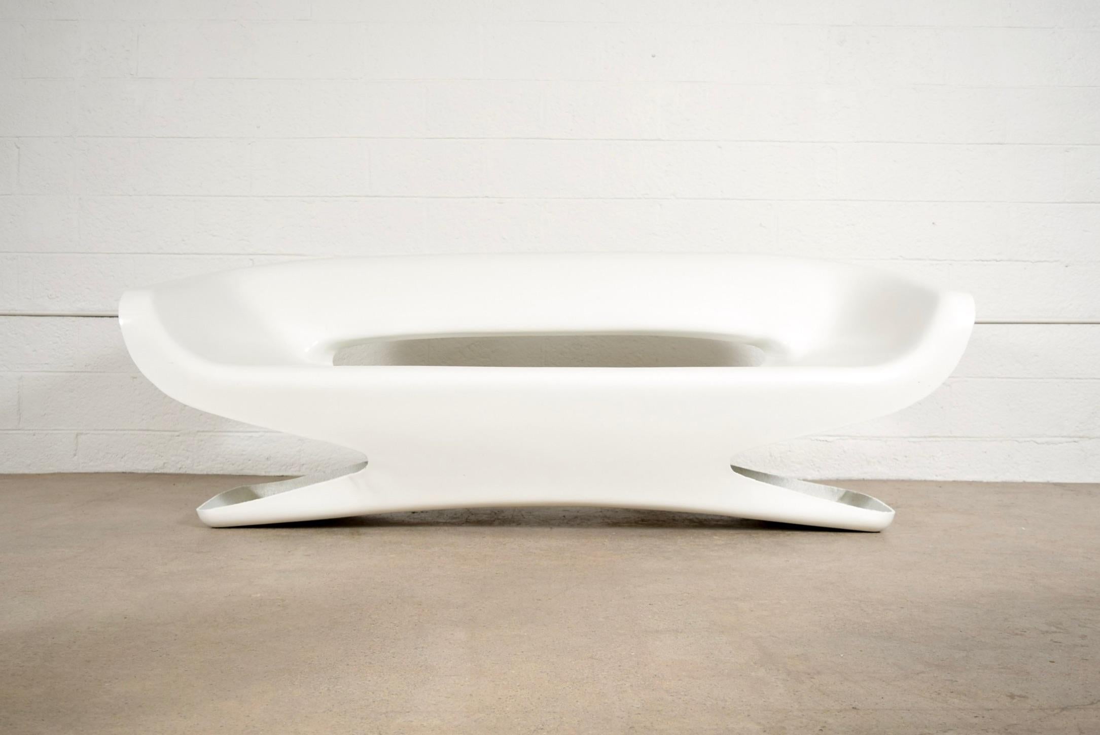 This vintage 1970s white fiberglass sofa has a cool space age sculptural design with clean lines and rounded edges. Well constructed from molded fiberglass with an open back and ends, it is truly unique and a striking statement piece.

Dimensions
W