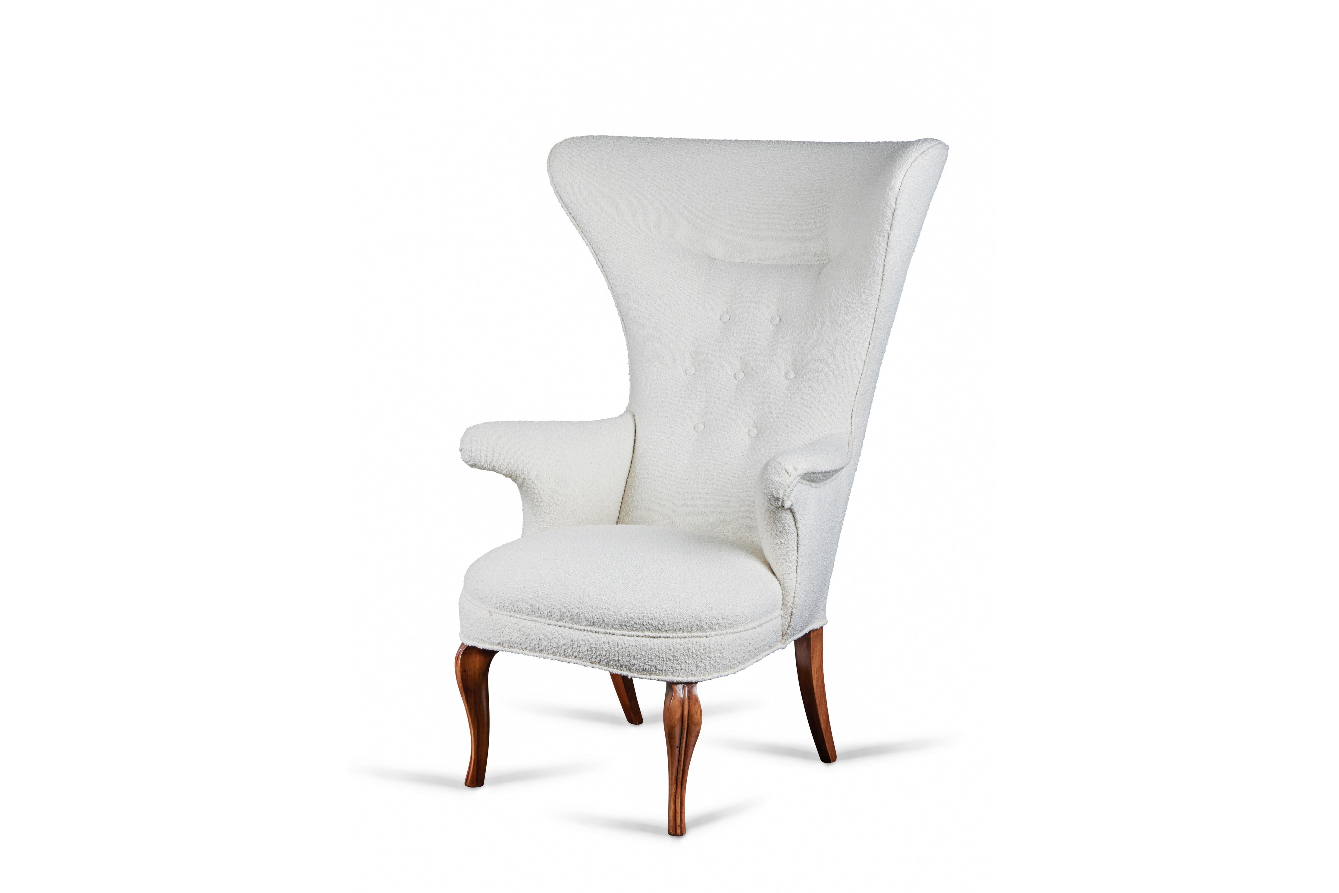 Dramatic and sculptural wing chair in the style of Fritz Henningsen, from the estate of French fashion designer Christian Audigier. Newly re-upholstered in an imported boucle fabric.