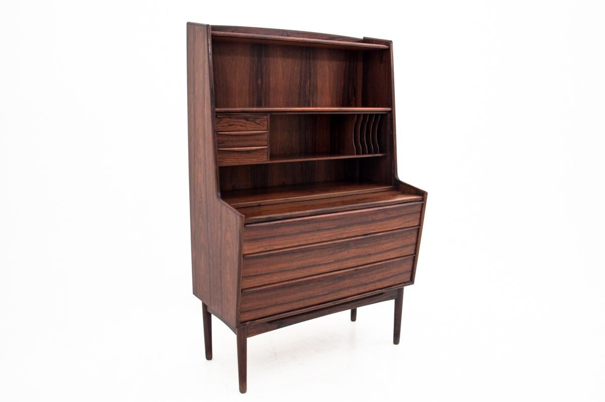 This stylish 1970s secretaire is made of rosewood, with plenty of drawers and compartments. It has a pull-out top, which adds to the furniture an additional desk function. The condition of the furniture is very good, it has been mildly renovated.