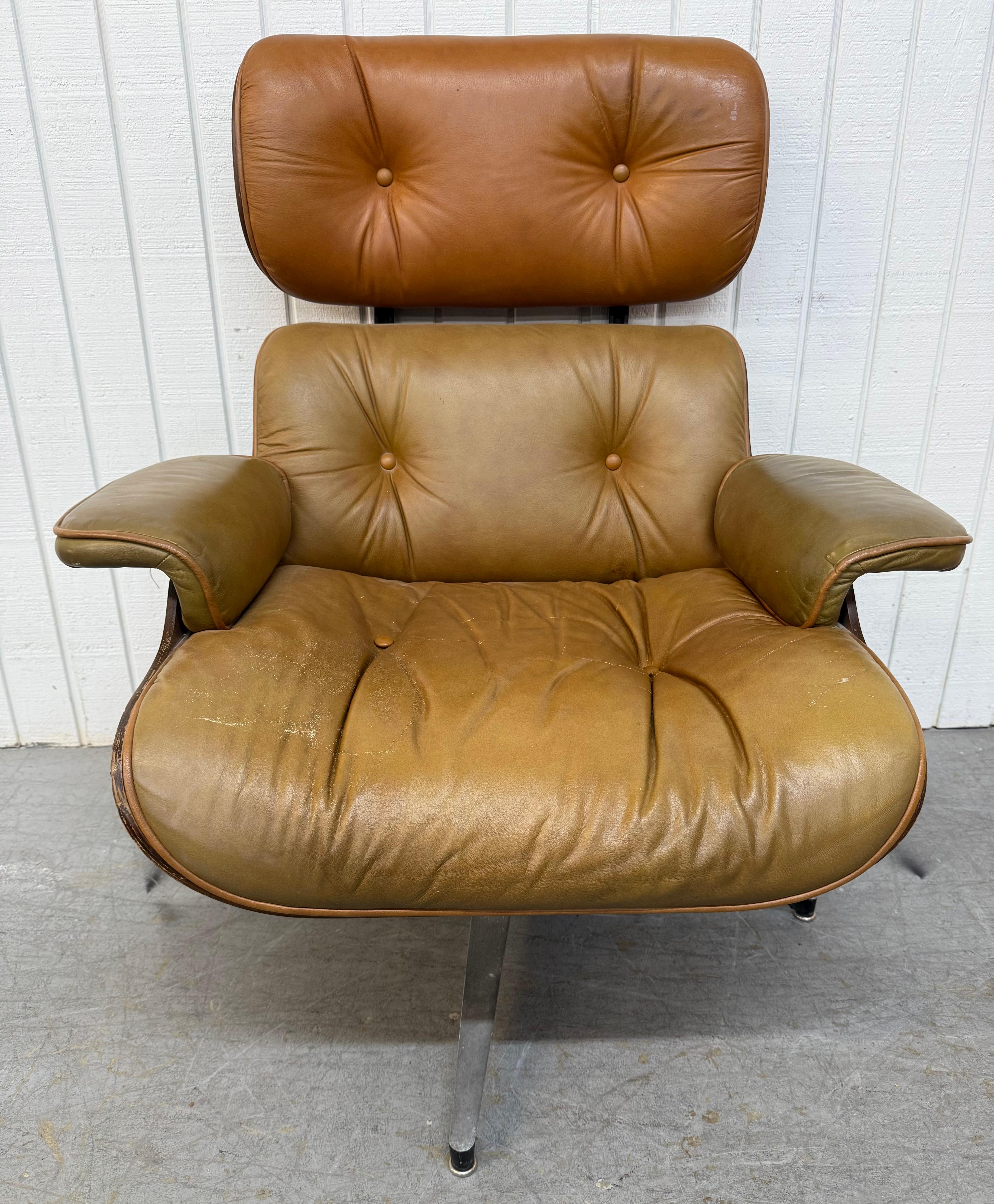 This listing is for a Mid-Century Modern Selig Leather Eames Chair & Ottoman. Featuring an iconic design by Charles & Ray Eames, original tan leather upholstery, walnut back, and swivel mechanism. This is an exceptional combination of quality and