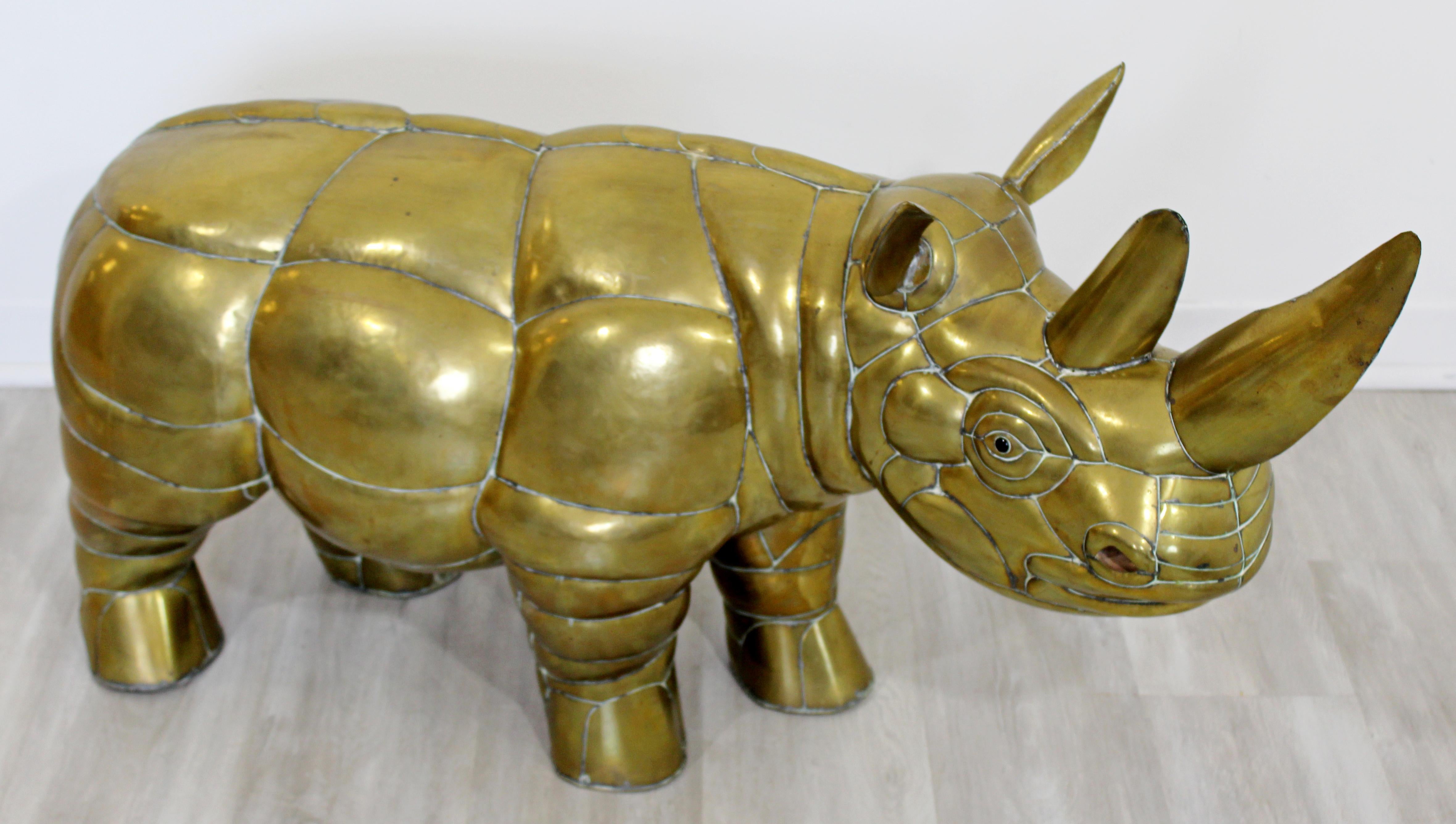 For your consideration is an eclectic, brass table or floor sculpture of a rhino, by Mexican artist Sergio Bustamante, circa 1970s. In excellent vintage condition. The dimensions are 44