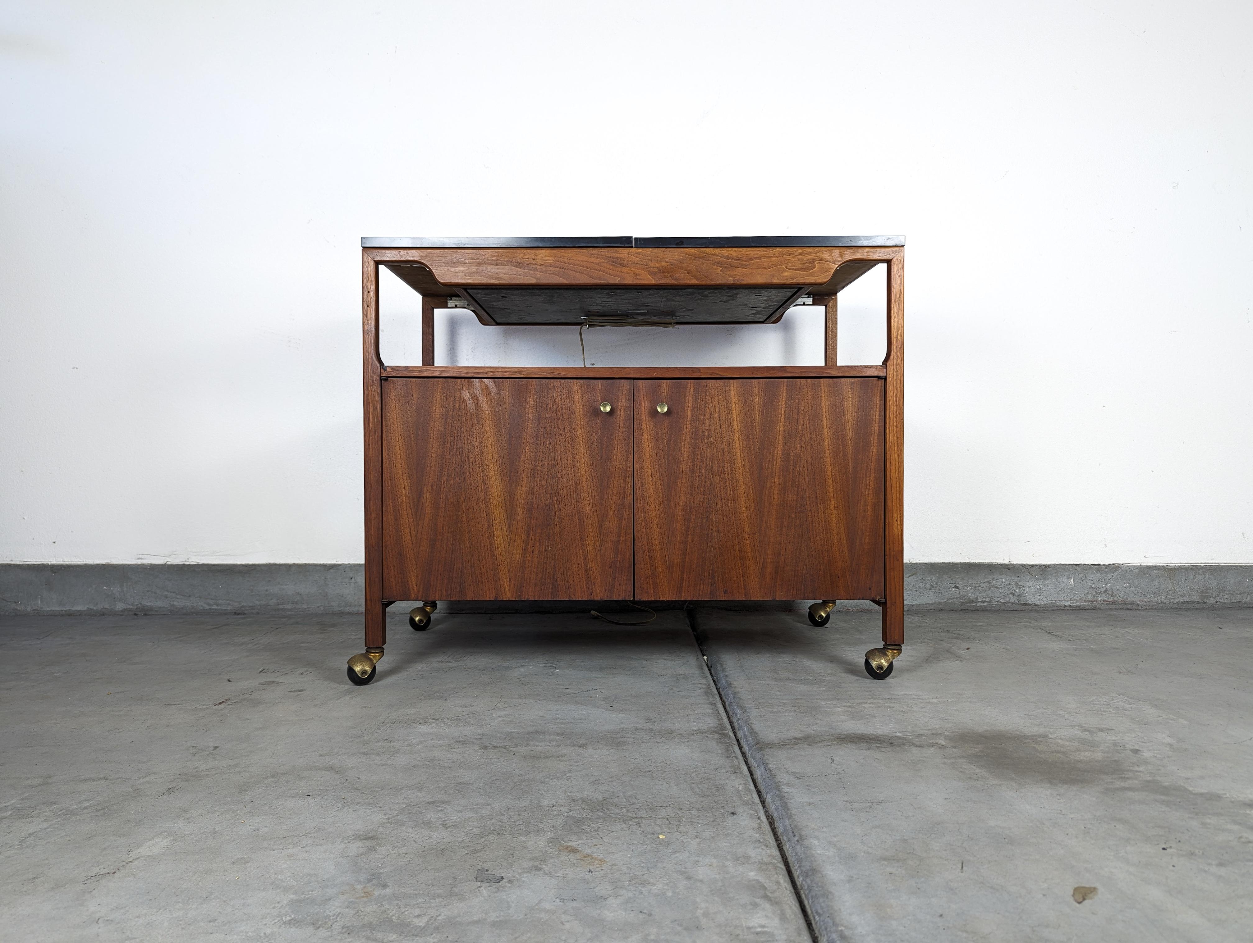 We are delighted to offer for sale this stunning, authentic mid-century modern serving cart, designed by the esteemed John Keal for Brown Saltman in the 1960s. A perfect blend of function and style, this piece is a must-have for lovers of vintage