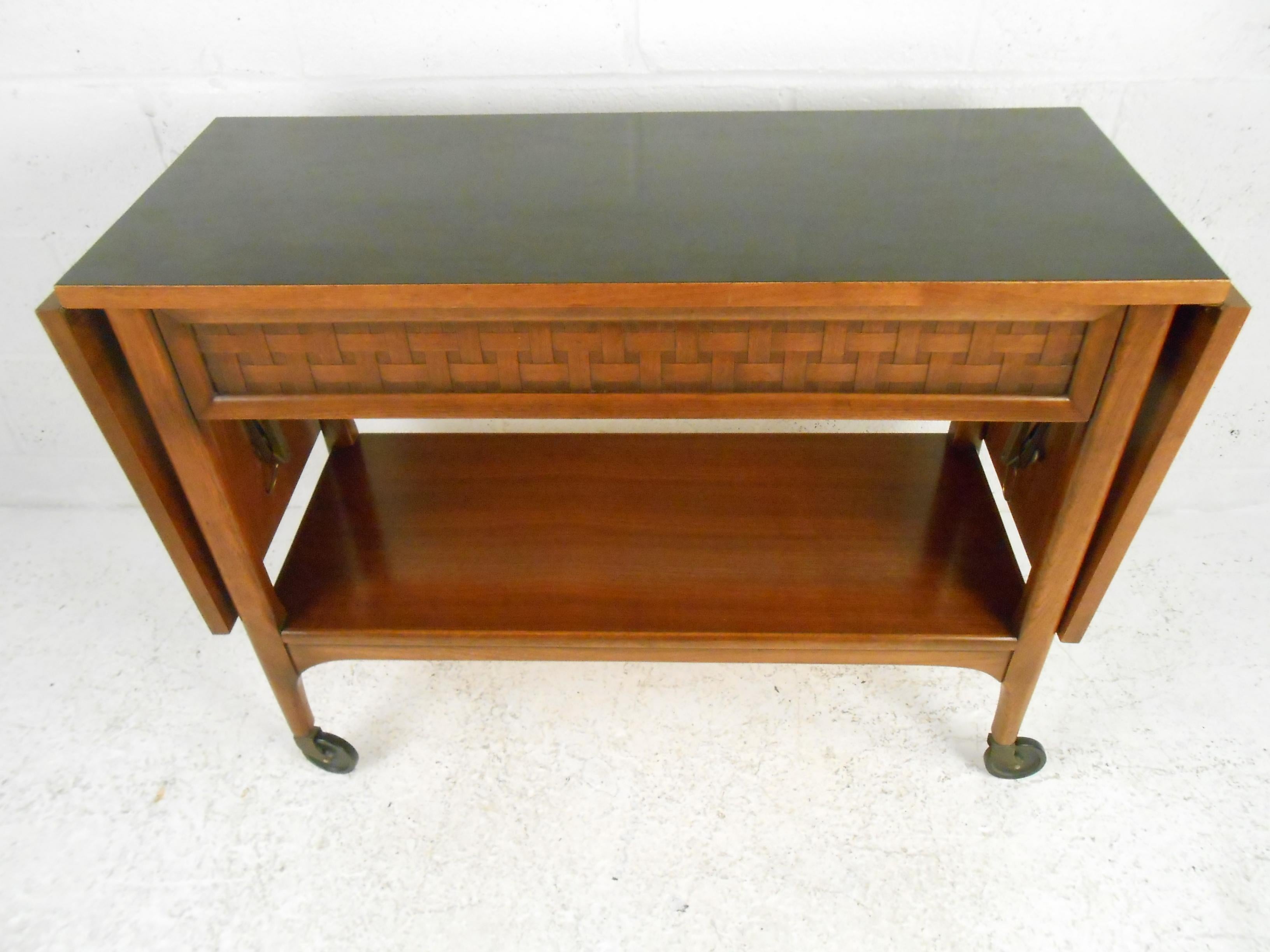 Handsome Mid-Century Modern serving cart manufactured by Lane Furniture Company in Altavista, Virginia. Drop-leaf extensions on either side of the tabletop extend the table's surface from 36