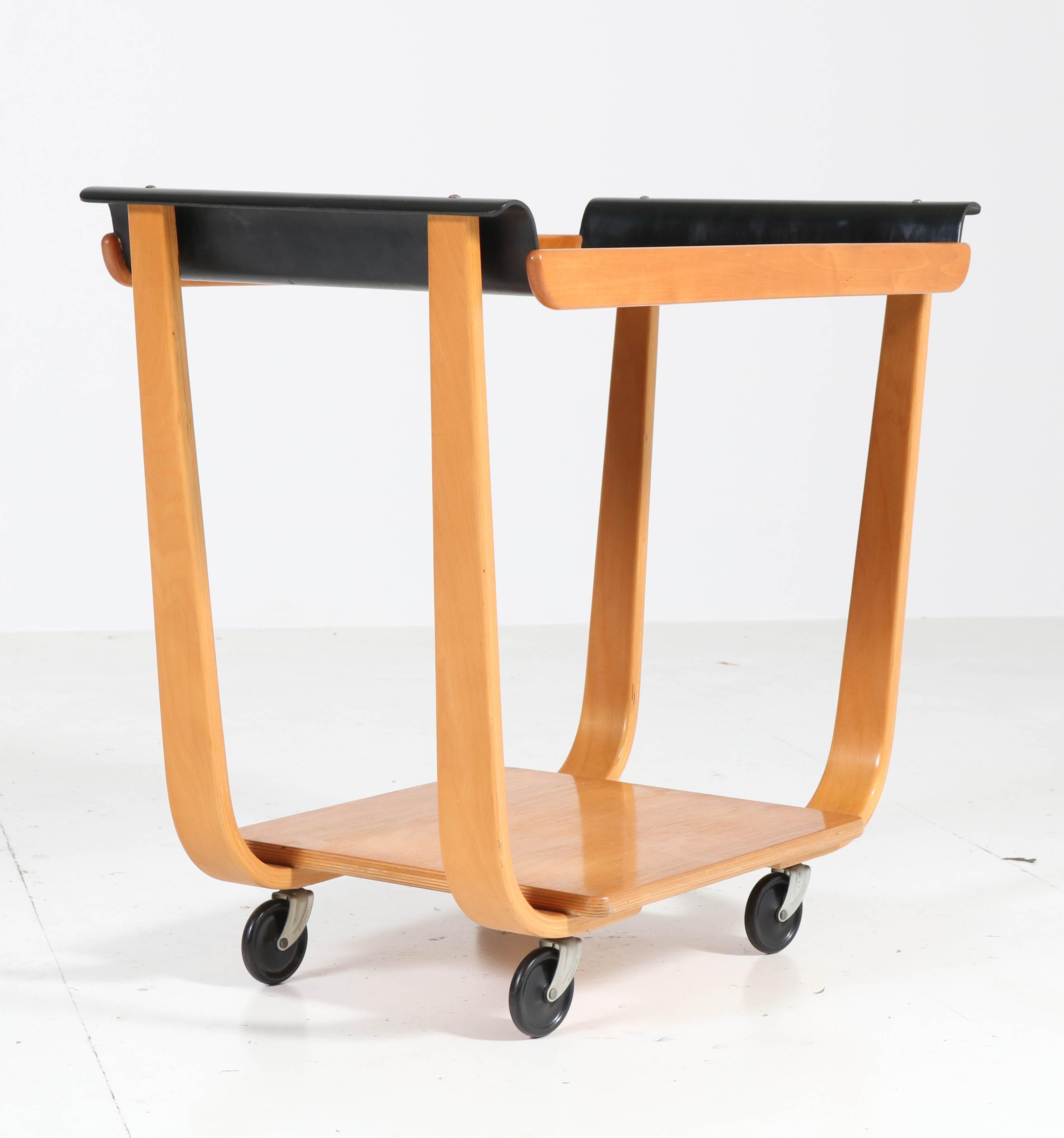 Wonderful Mid-Century Modern serving trolley.
Design by Cees Braakman for UMS Pastoe.
Iconic Dutch design from the 1950s.
Birch laminated plywood with black lacquered top.
In very good original condition with minor wear consistent with age and